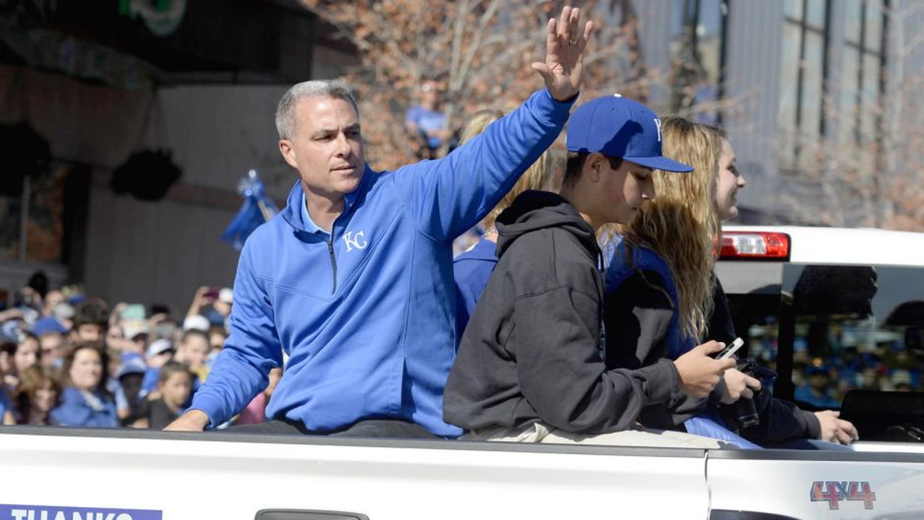 Nov 3, 2015; Kansas City, MO, USA; Kansas City Royals general manager Dayton Moore waves to fans at the World Series parade. Mandatory Credit: John Rieger-USA TODAY Sports