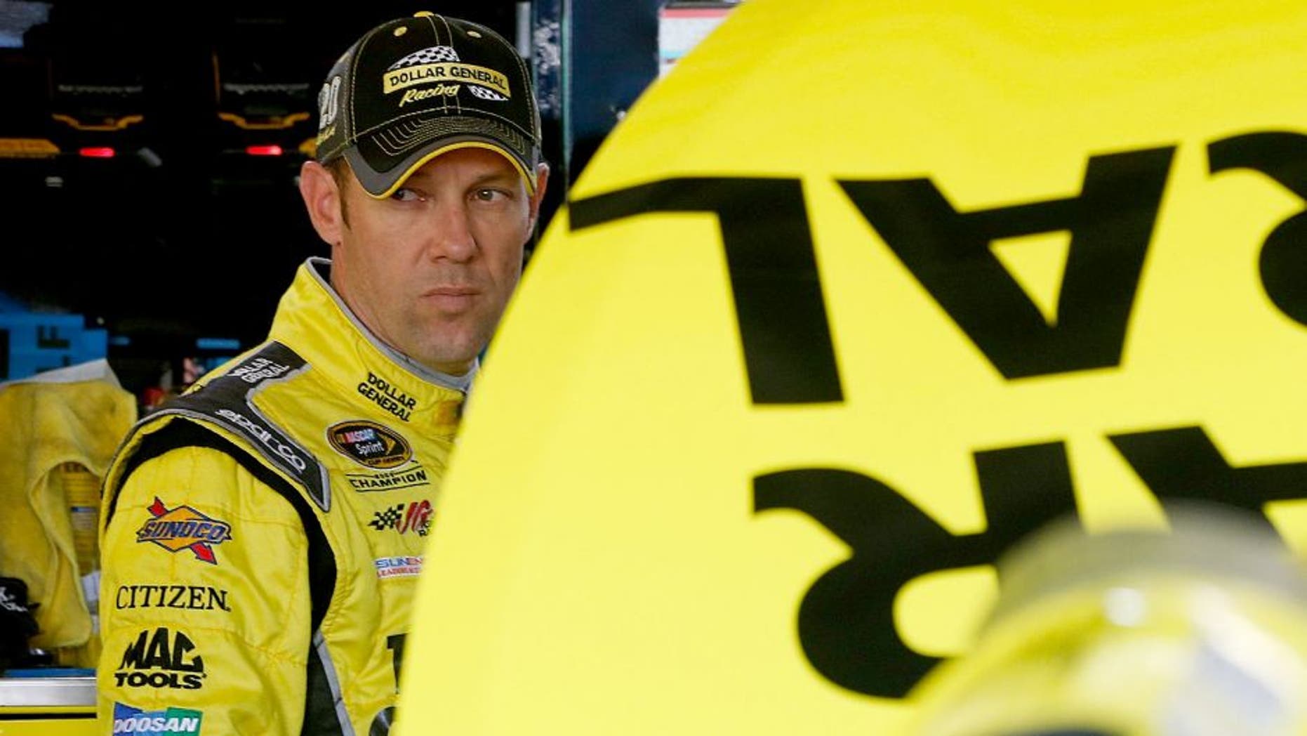 KANSAS CITY, KS - OCTOBER 16: Matt Kenseth, driver of the #20 Dollar General Toyota, stands in the garage area during practice for the NASCAR Sprint Cup Series Hollywood Casino 400 at Kansas Speedway on October 16, 2015 in Kansas City, Kansas. (Photo by Brian Lawdermilk/NASCAR via Getty Images)