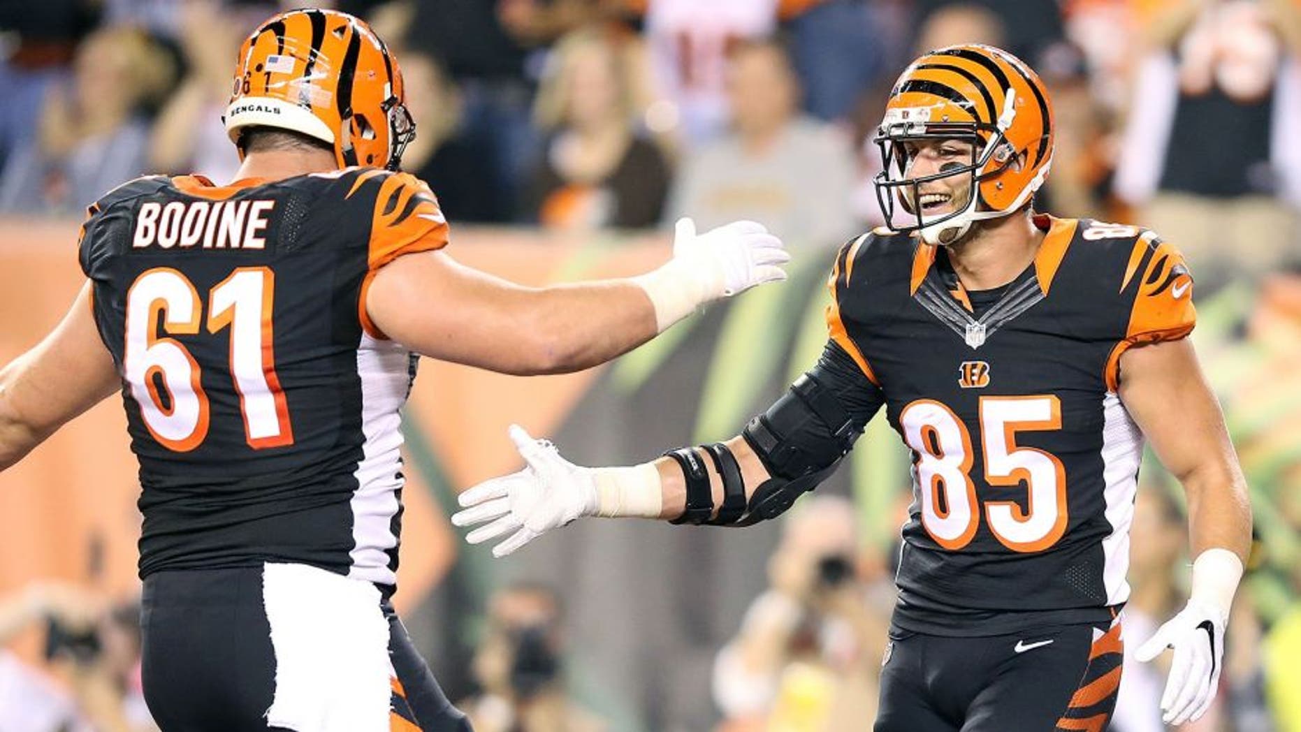 CINCINNATI, OH - NOVEMBER 5: Tyler Eifert #85 of the Cincinnati Bengals is congratulated by Russell Bodine #61 of the Cincinnati Bengals after scoring a touchdown during the second quarter of the game against the Cleveland Browns at Paul Brown Stadium on November 5, 2015 in Cincinnati, Ohio. (Photo by Andy Lyons/Getty Images)