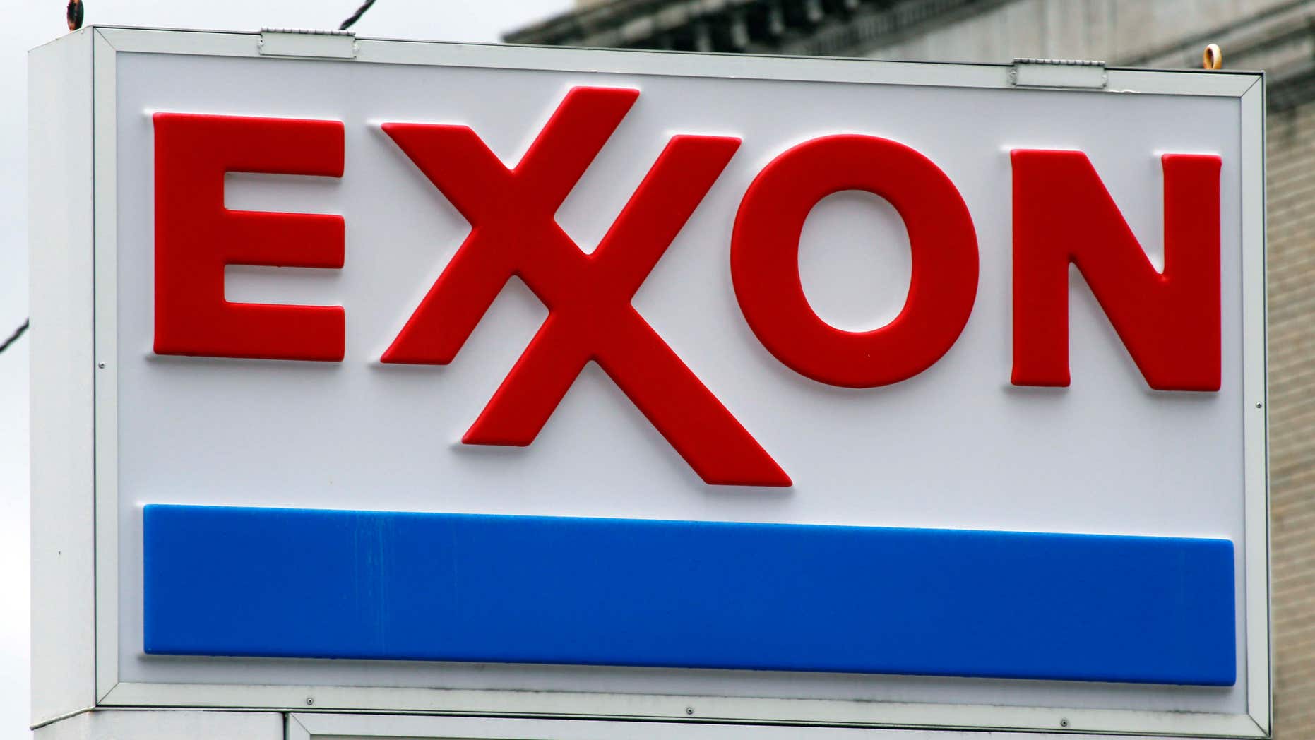 FILE - This April 29, 2014, file photo shows an Exxon sign at a mini-mart in Dormont, Pa.