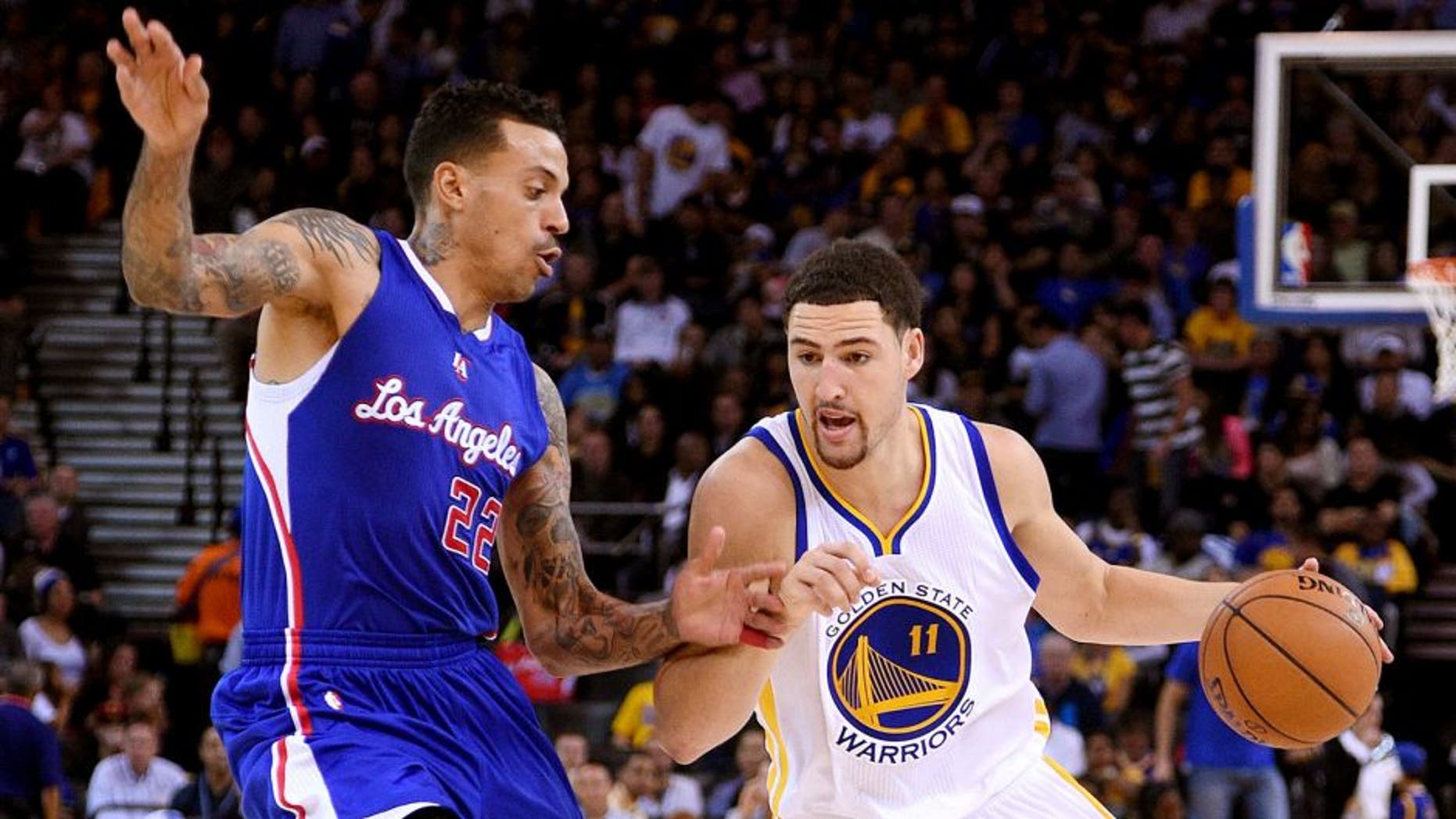 November 5, 2014; Oakland, CA, USA; Golden State Warriors guard Klay Thompson (11) dribbles the basketball against Los Angeles Clippers forward Matt Barnes (22) during the third quarter at Oracle Arena. The Warriors defeated the Clippers 121-104. Mandatory Credit: Kyle Terada-USA TODAY Sports