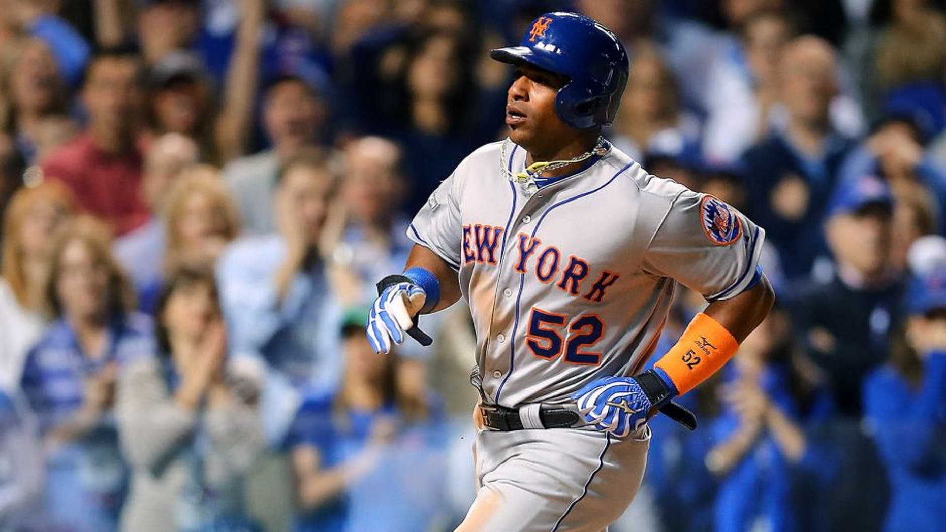CHICAGO, IL - OCTOBER 20: Yoenis Cespedes #52 of the New York Mets scores a run off of a wild pitch thrown by Trevor Cahill #53 of the Chicago Cubs in the sixth inning during game three of the 2015 MLB National League Championship Series at Wrigley Field on October 20, 2015 in Chicago, Illinois. (Photo by Elsa/Getty Images)