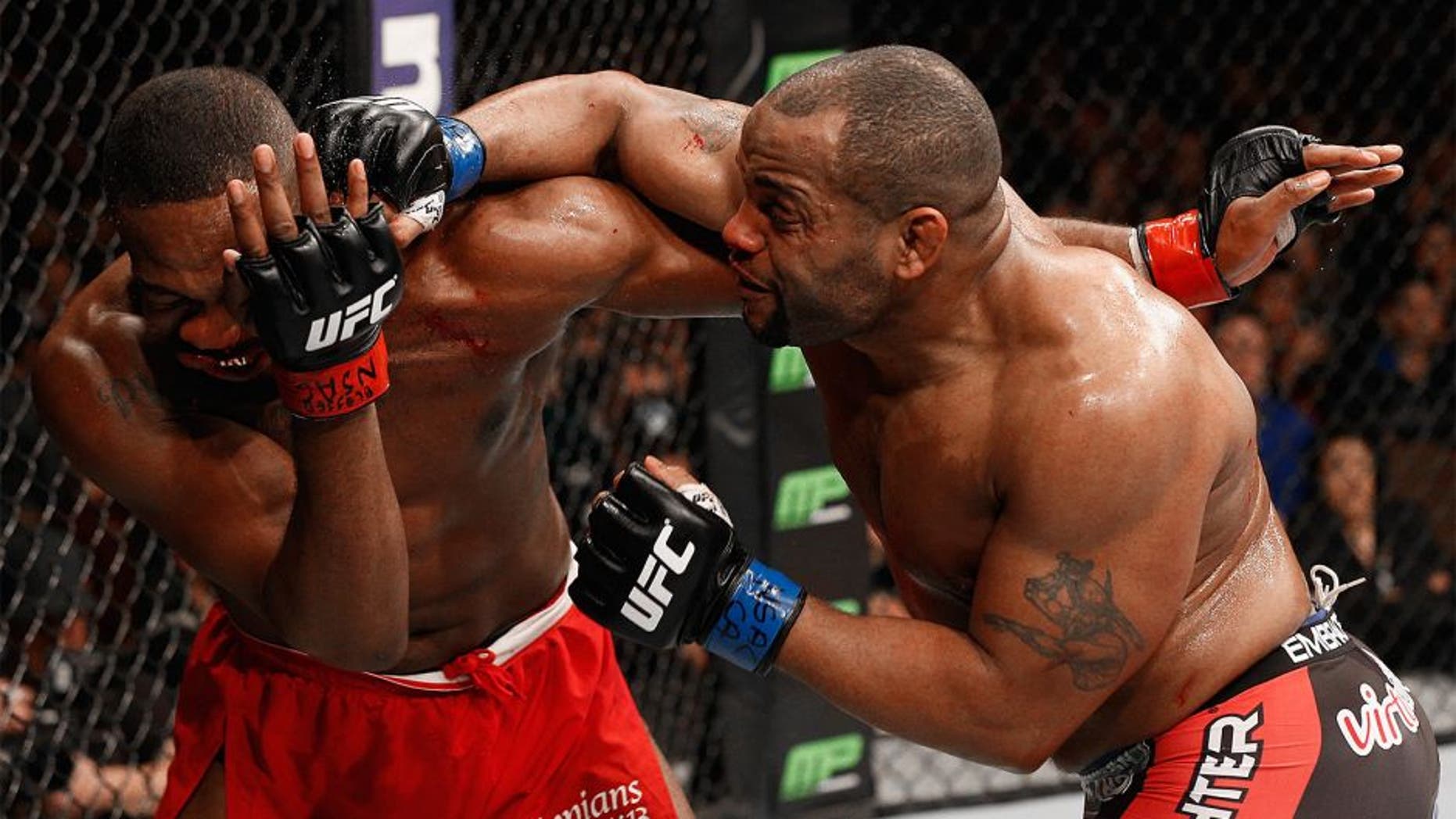 LAS VEGAS, NV - JANUARY 03: Daniel Cormier (R) punches Jon Jones (L) in their UFC light heavyweight championship bout during the UFC 182 event at the MGM Grand Garden Arena on January 3, 2015 in Las Vegas, Nevada. (Photo by Josh Hedges/Zuffa LLC/Zuffa LLC via Getty Images)