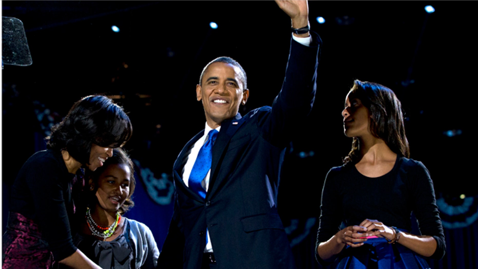 Nov. 7, 2012: President Barack Obama, accompanied by first lady Michelle Obama and daughters Malia and Sasha arrive at the election night party in Chicago.