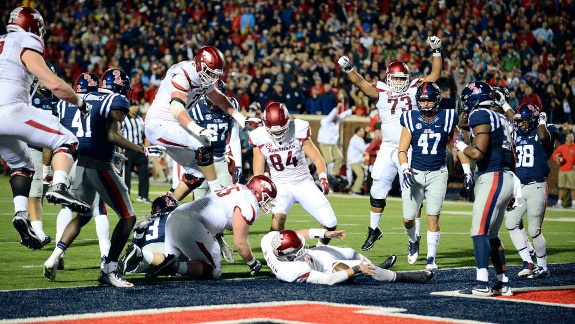 Nov 7, 2015; Oxford, MS, USA; Arkansas Razorbacks players celebrate after quarterback Brandon Allen (10) scored a two point conversion to win in over time in the game at Vaught-Hemingway Stadium. Arkansas won 53-52. Mandatory Credit: Matt Bush-USA TODAY Sports