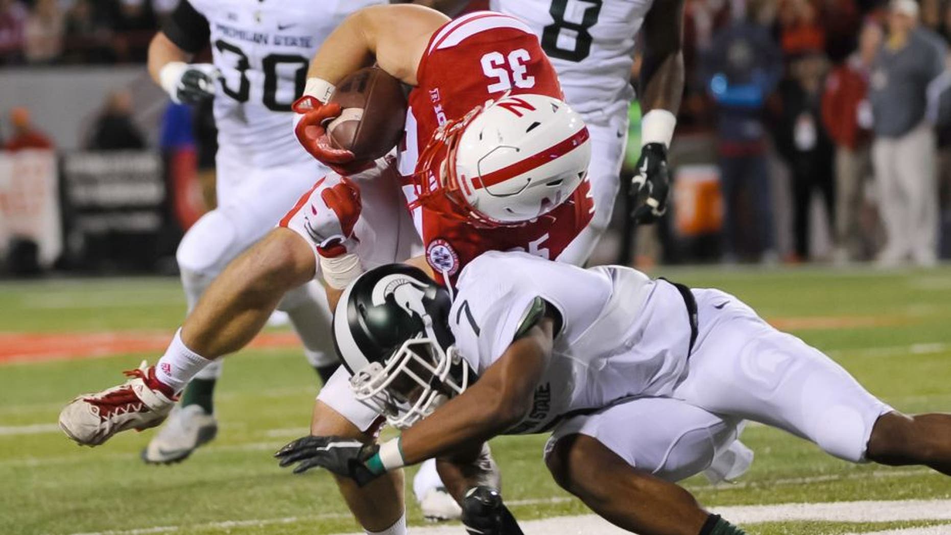 Nov 7, 2015; Lincoln, NE, USA; Nebraska Cornhuskers fullback Andy Janovich (35) carries the ball as Michigan State Spartans defensive back Demetrious Cox (7) tackles at Memorial Stadium. Mandatory Credit: Steven Branscombe-USA TODAY Sports