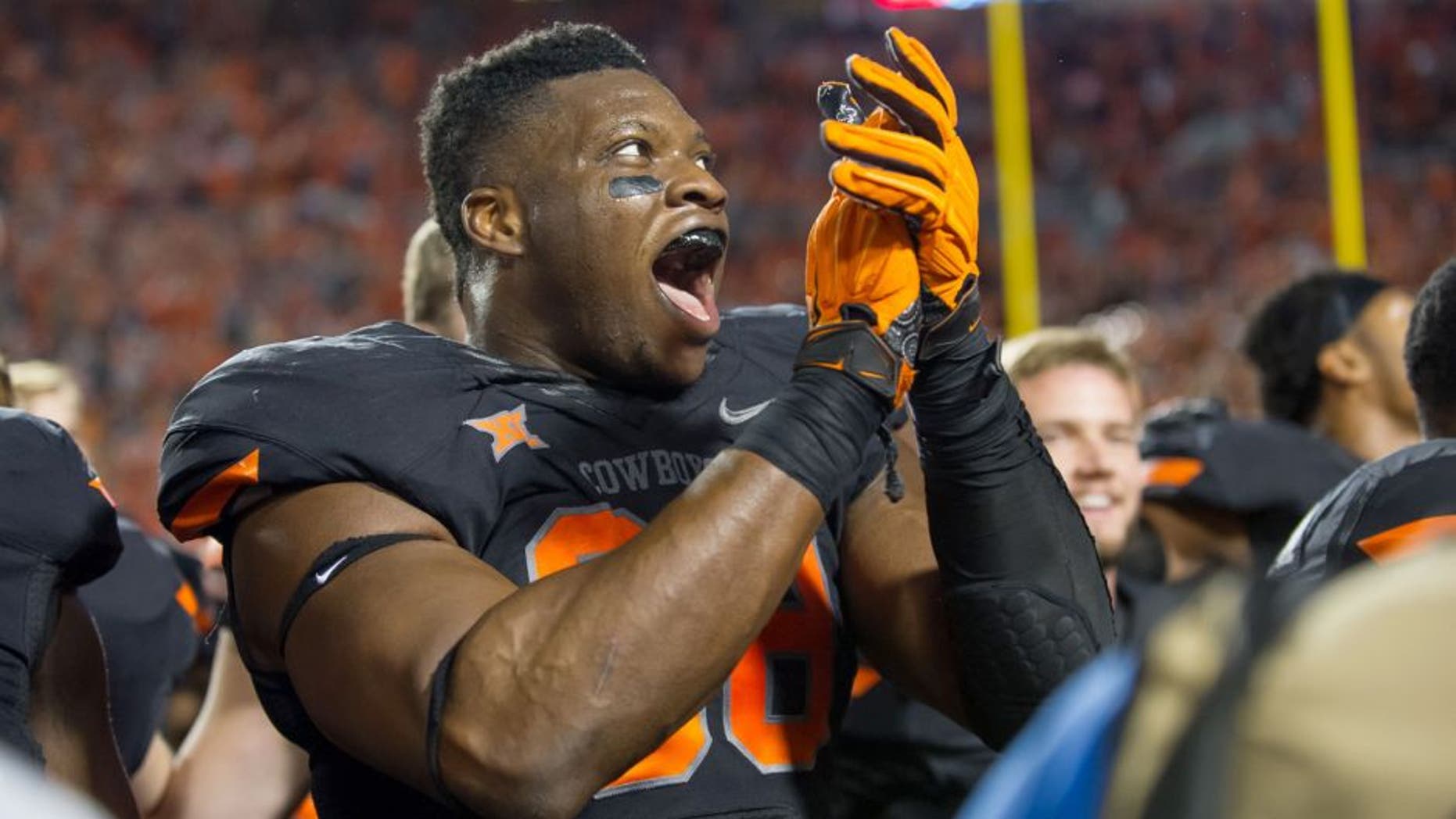 Nov 7, 2015; Stillwater, OK, USA; Oklahoma State Cowboys defensive end Emmanuel Ogbah (38) celebrates after the game against the TCU Horned Frogs at Boone Pickens Stadium. OSU won 49-29. Mandatory Credit: Rob Ferguson-USA TODAY Sports