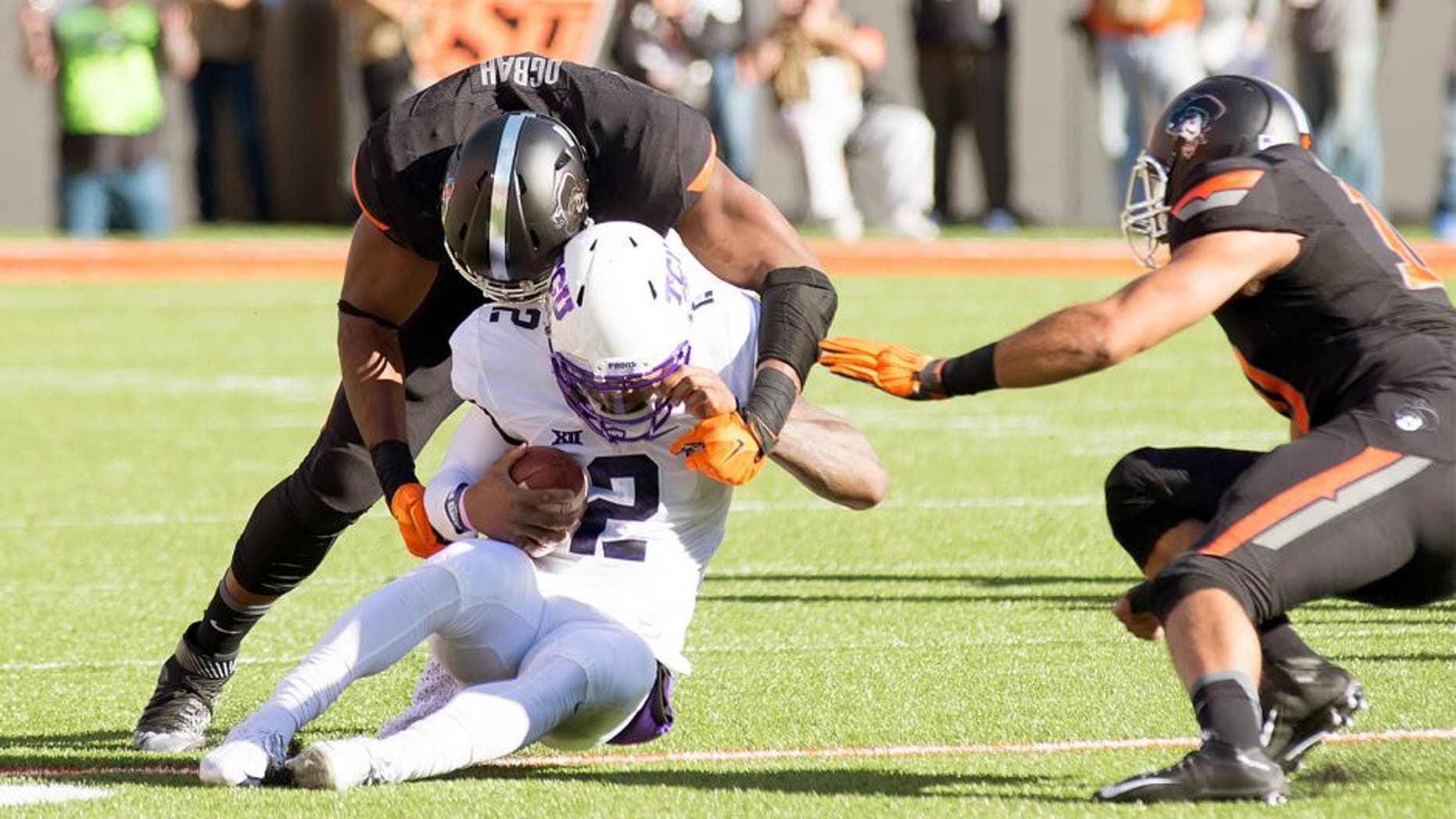 Nov 7, 2015; Stillwater, OK, USA; TCU Horned Frogs quarterback Trevone Boykin (2) tackled by Oklahoma State Cowboys defensive end Emmanuel Ogbah (38) during the first quarter at Boone Pickens Stadium. Mandatory Credit: Rob Ferguson-USA TODAY Sports