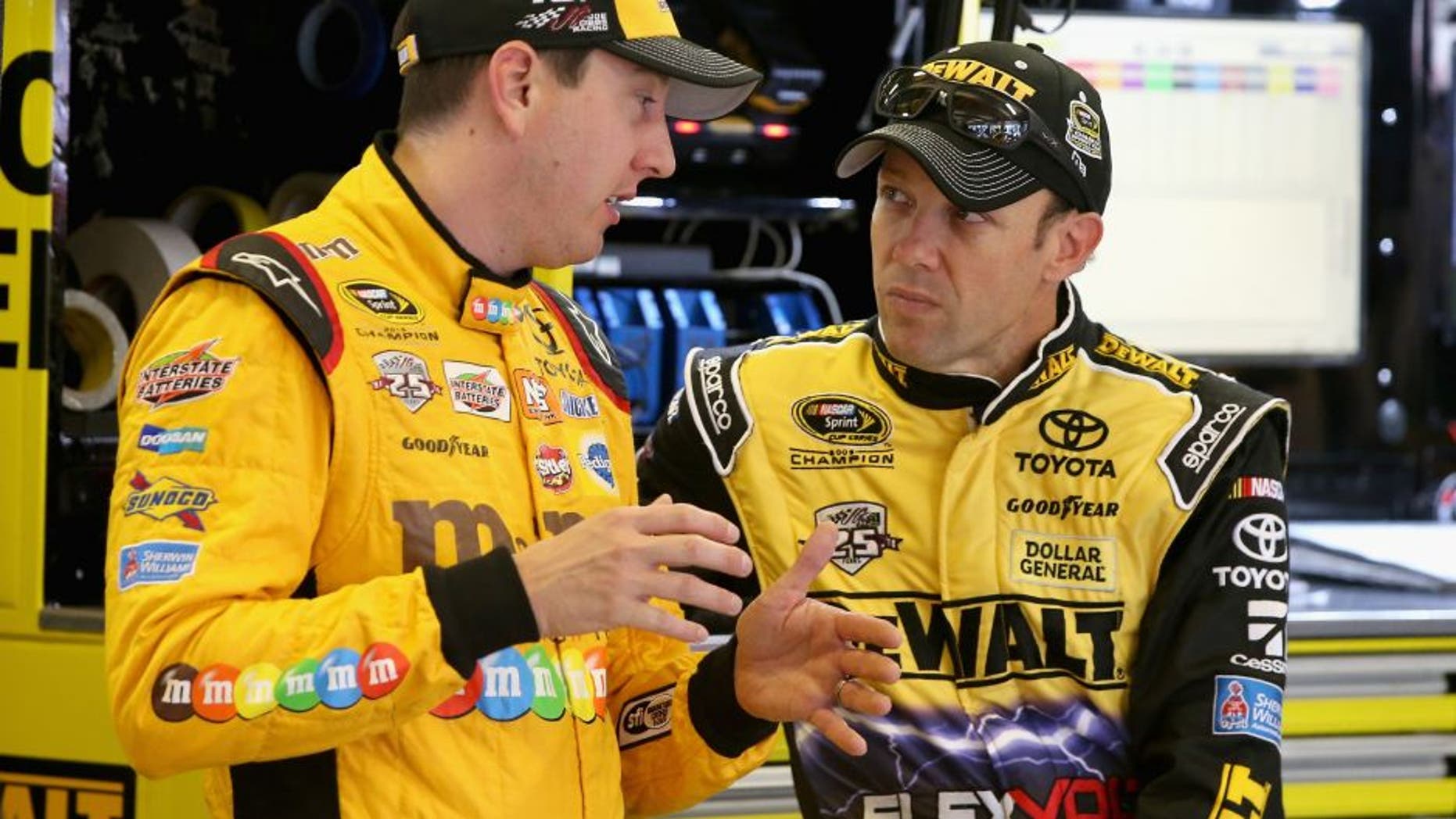 FORT WORTH, TX - NOVEMBER 04: Kyle Busch, driver of the #18 M&M's Toyota, and Matt Kenseth, driver of the #20 DEWALT FLEXVOLT Toyota, talk in the garage area during practice for the NASCAR Sprint Cup Series AAA Texas 500 at Texas Motor Speedway on November 4, 2016 in Fort Worth, Texas. (Photo by Sean Gardner/NASCAR via Getty Images)
