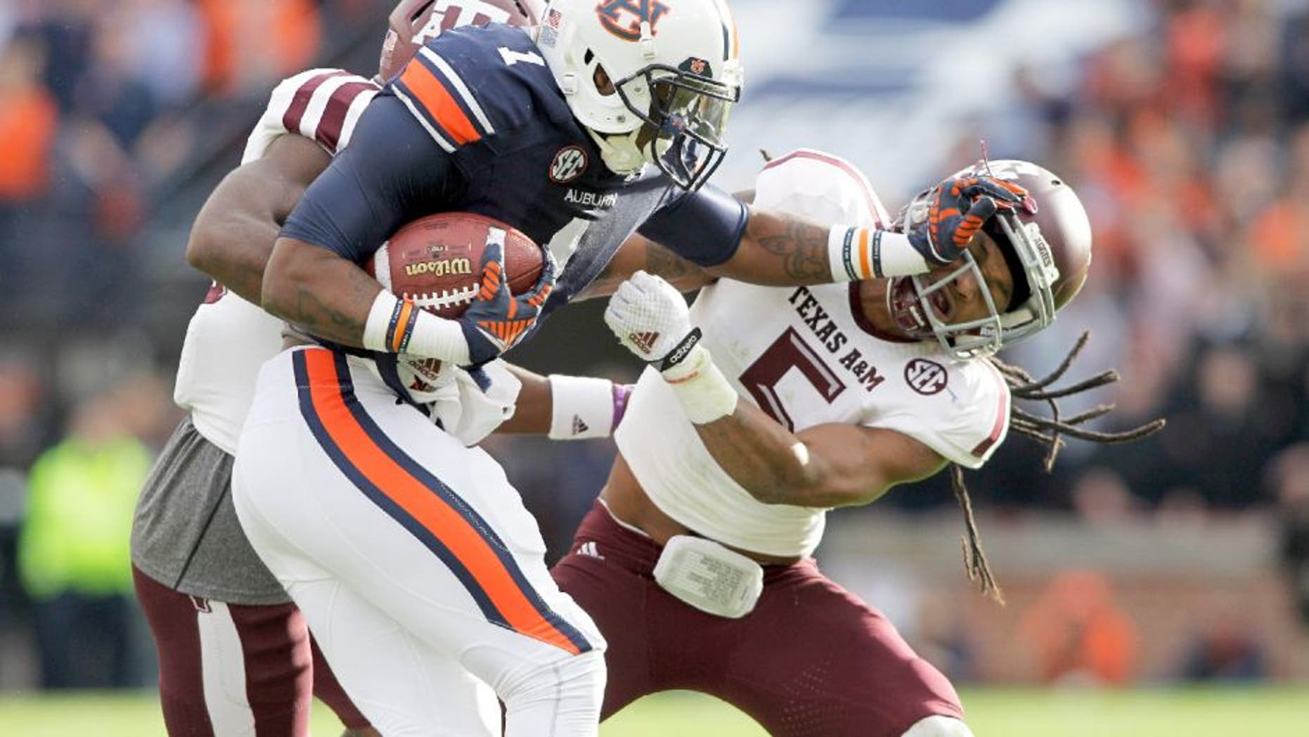 Nov 8, 2014; Auburn, AL, USA; Auburn Tigers receiver receiver D'haquille Williams (1) blocks Texas A&M Aggies defensive back Floyd Raven, Sr. (5) during the first half at Jordan Hare Stadium. Mandatory Credit: John Reed-USA TODAY Sports
