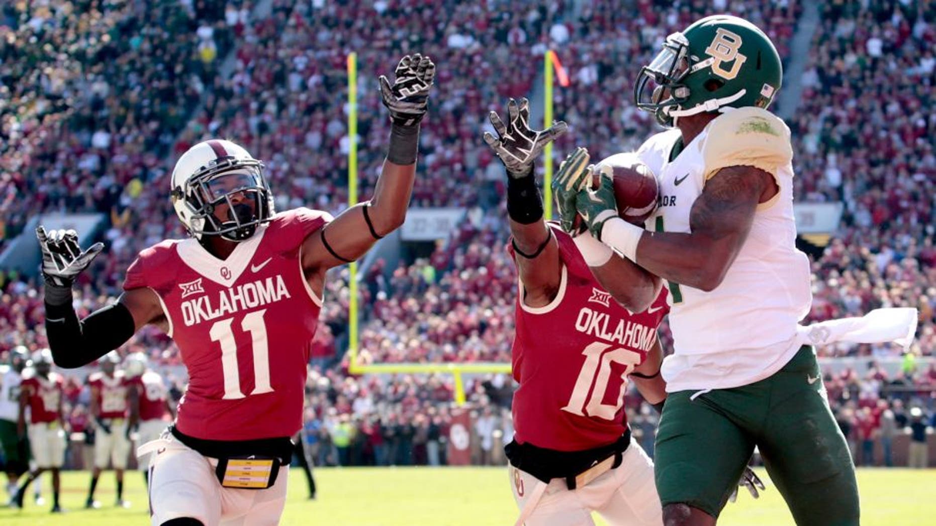 NORMAN, OK - NOVEMBER 8: Running back Corey Coleman #1 of the Baylor Bears catches a touchdown pass as safety Steven Parker #11 and safety Quentin Hayes #10 of the Oklahoma Sooners defends November 8, 2014 at Gaylord Family-Oklahoma Memorial Stadium in Norman, Oklahoma. (Photo by Brett Deering/Getty Images)