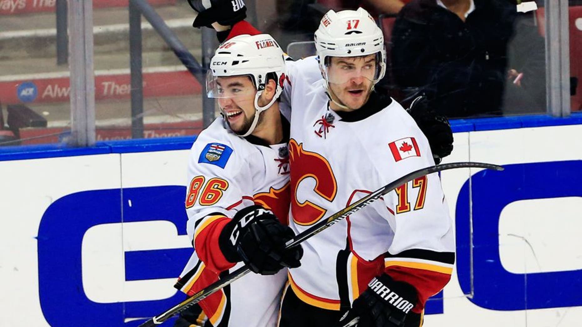 Nov 8, 2014; Sunrise, FL, USA; Calgary Flames left wing Lance Bouma (17) celebrates his goal against the Florida Panthers with center Josh Jooris (86) in the third period at BB&T Center. The Flames won 6-4. Mandatory Credit: Robert Mayer-USA TODAY Sports