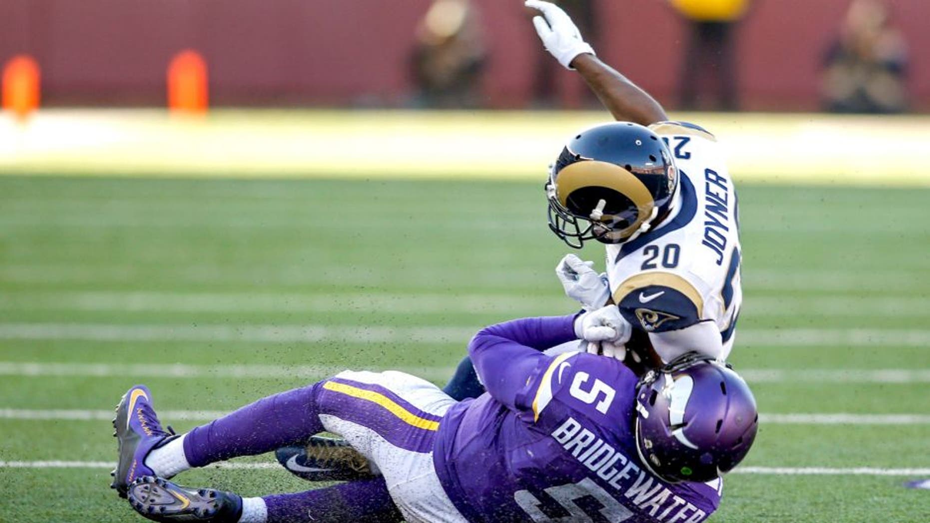 Nov 8, 2015; Minneapolis, MN, USA; St. Louis Rams cornerback Lamarcus Joyner (20) collides with Minnesota Vikings quarterback Teddy Bridgewater (5) for a personal foul in the fourth quarter at TCF Bank Stadium. Bridgewater did not return. The Vikings win 21-18. Mandatory Credit: Bruce Kluckhohn-USA TODAY Sports