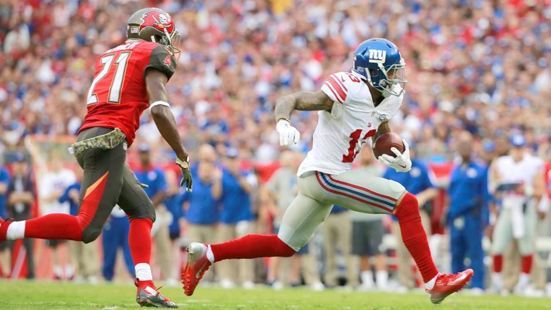 Nov 8, 2015; Tampa, FL, USA; New York Giants wide receiver Odell Beckham (13) runs with the ball as Tampa Bay Buccaneers cornerback Alterraun Verner (21) defends during the first quarter at Raymond James Stadium. Mandatory Credit: Kim Klement-USA TODAY Sports