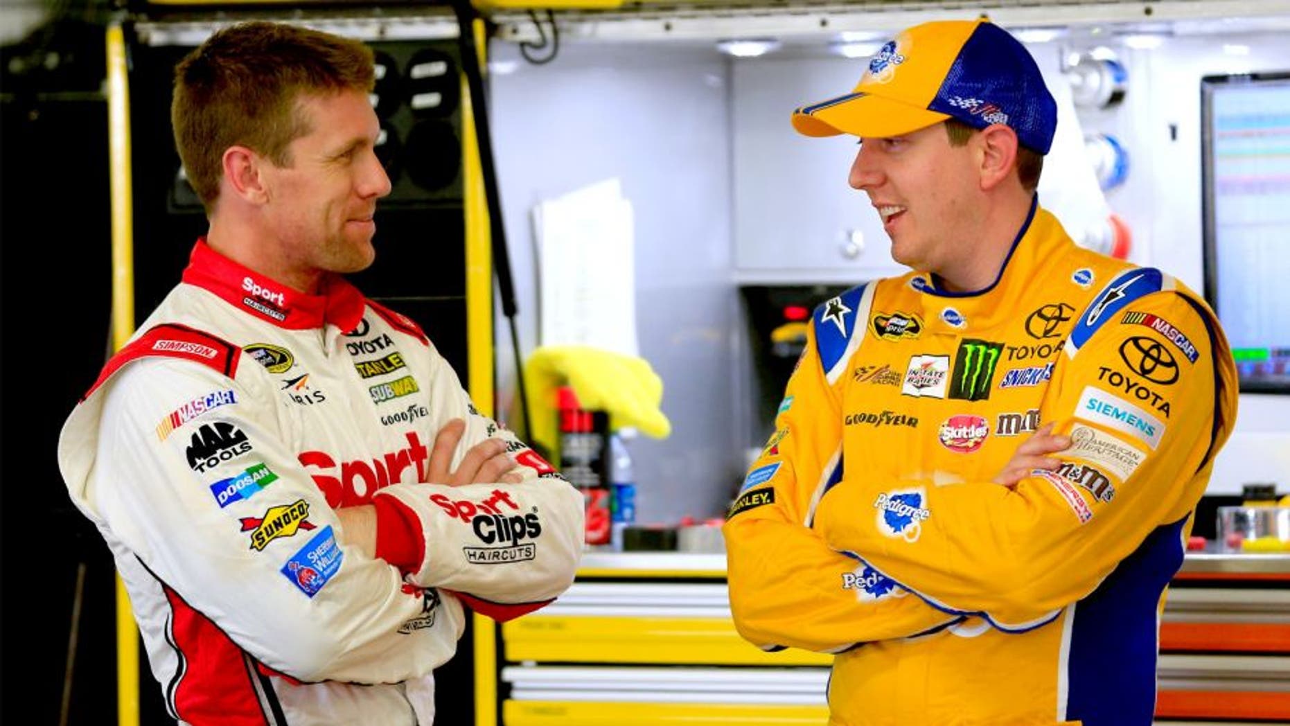 LOUDON, NH - SEPTEMBER 25: Carl Edwards, left, driver of the #19 Sport Clips Toyota, talks with Kyle Busch, driver of the #18 Pedigree Toyota, in the garage area during practice for the NASCAR Sprint Cup Series Sylvania 300 at New Hampshire Motor Speedway on September 25, 2015 in Loudon, New Hampshire. (Photo by Chris Trotman/Getty Images)