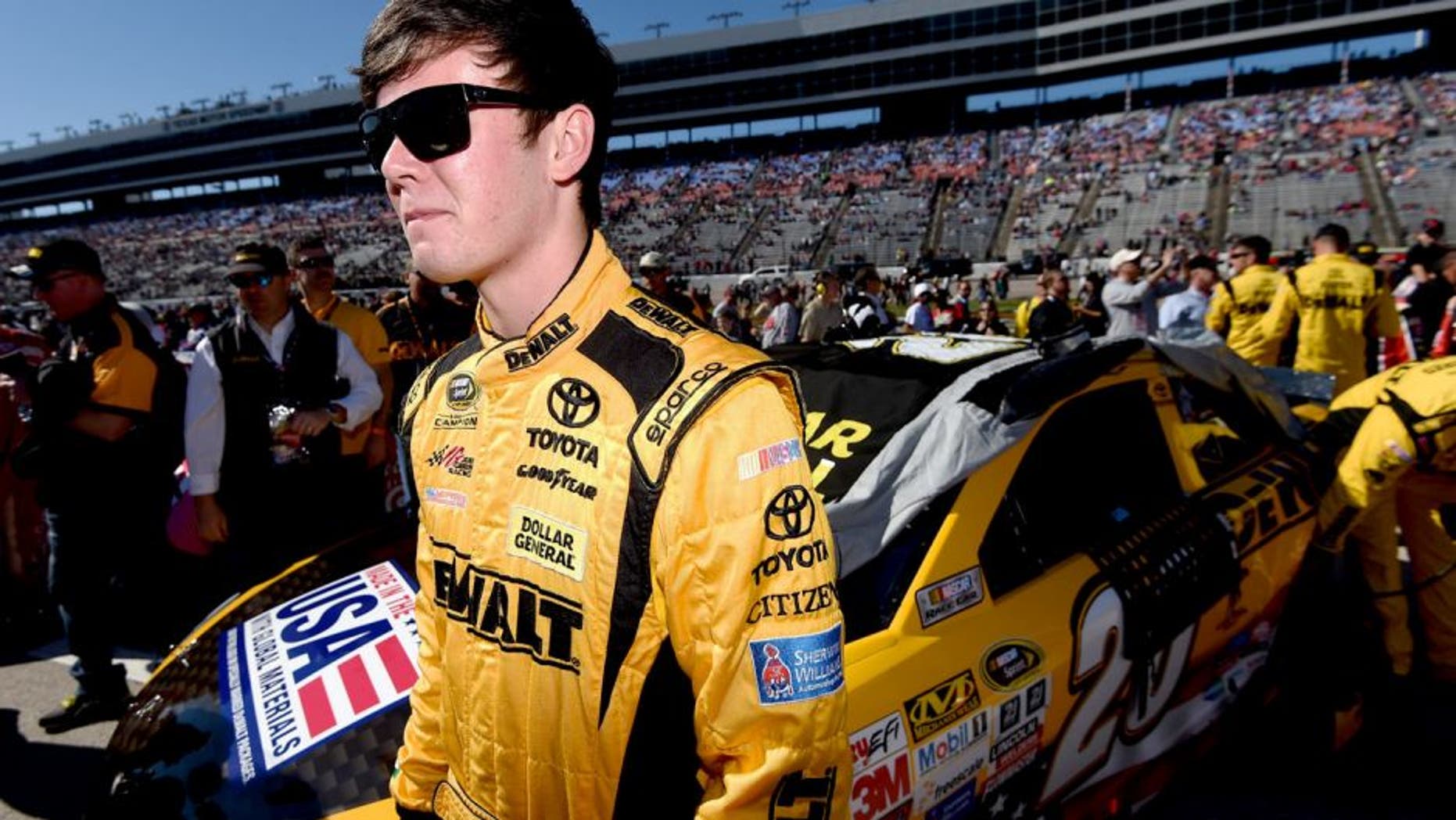 FORT WORTH, TX - NOVEMBER 08: Erik Jones, driver of the #20 DeWalt Toyota, stands on the grid during the NASCAR Sprint Cup Series AAA Texas 500 at Texas Motor Speedway on November 8, 2015 in Fort Worth, Texas. (Photo by Rainier Ehrhardt/NASCAR via Getty Images)