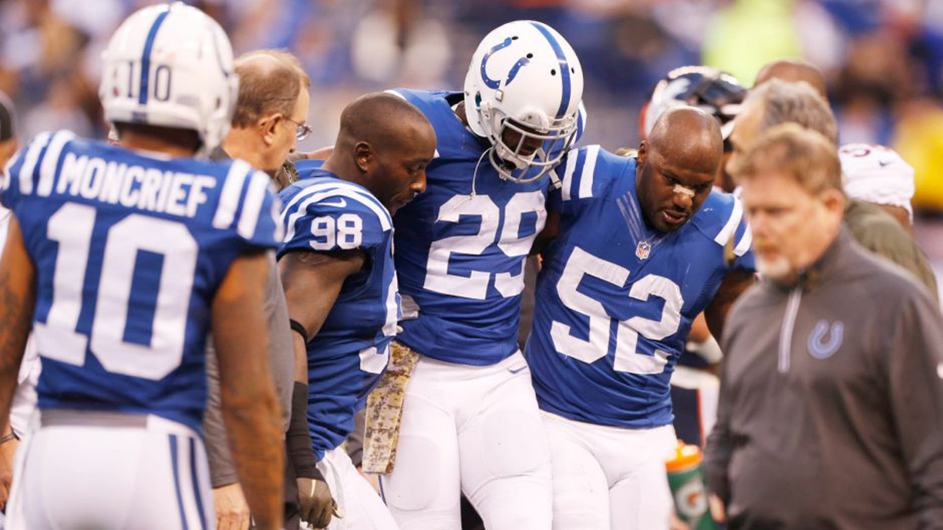 Nov 8, 2015; Indianapolis, IN, USA; Indianapolis Colts safety Mike Adams (29) is helped off the field by linebackers Robert Mathis (98) and D'Qwell Jackson during a game against the Denver Broncos at Lucas Oil Stadium. Mandatory Credit: Brian Spurlock-USA TODAY Sports