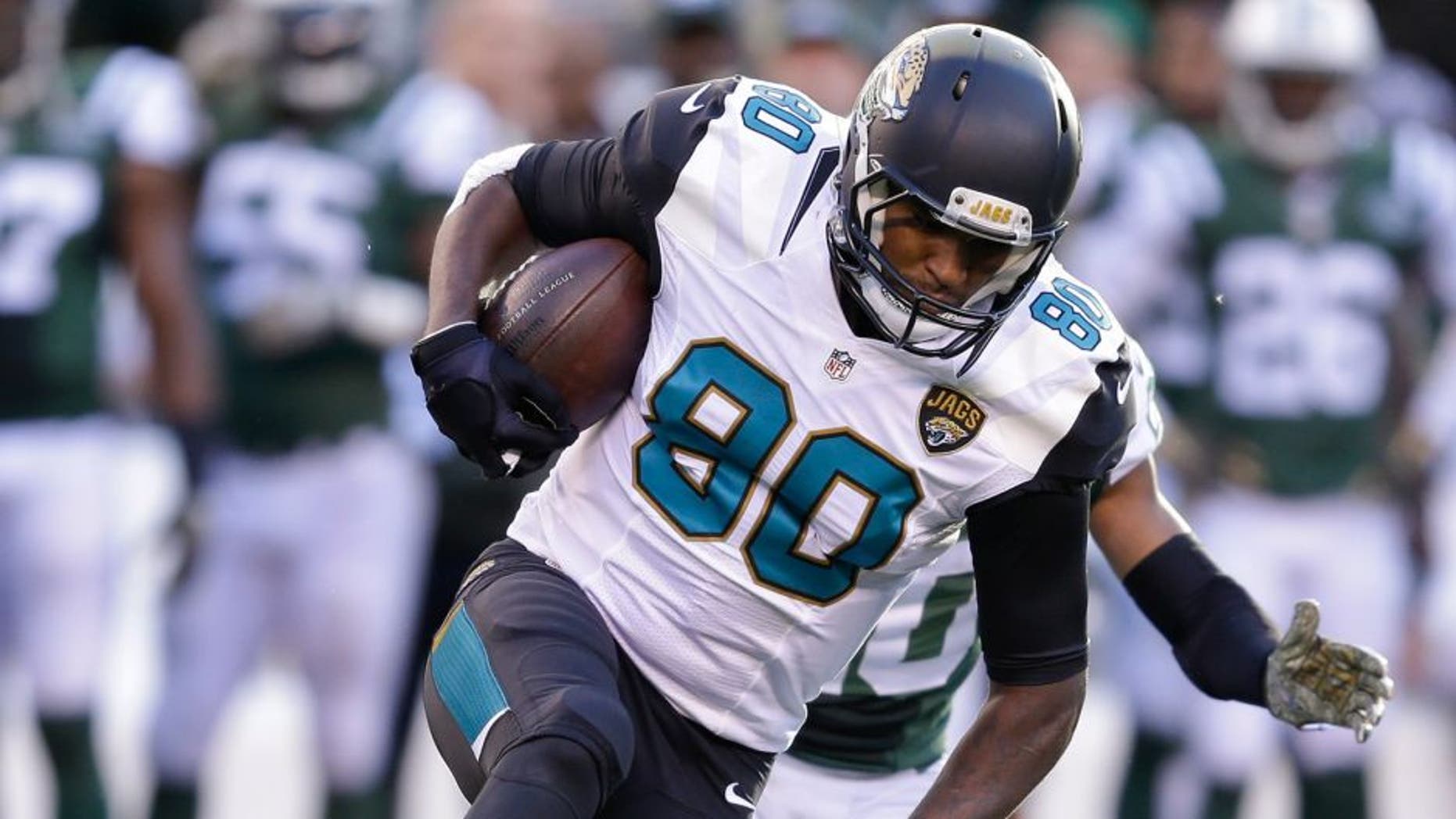 Jacksonville Jaguars tight end Julius Thomas (80) is tackled by New York Jets strong safety Dion Bailey (34) during the fourth quarter of an NFL football game, Sunday, Nov. 8, 2015, in East Rutherford, N.J. (AP Photo/Seth Wenig)