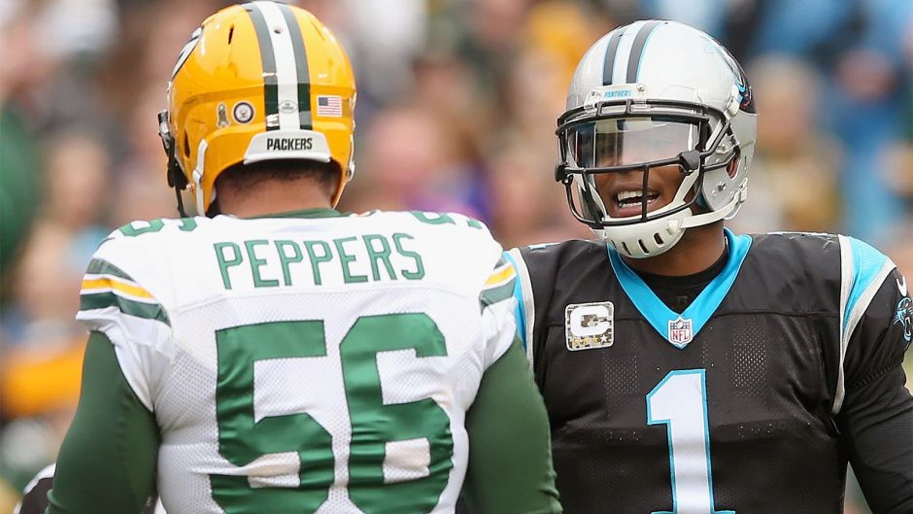 CHARLOTTE, NC - NOVEMBER 08: Cam Newton #1 of the Carolina Panthers talks to Julius Peppers #56 of the Green Bay Packers in the 1st half during their game at Bank of America Stadium on November 8, 2015 in Charlotte, North Carolina. (Photo by Streeter Lecka/Getty Images)