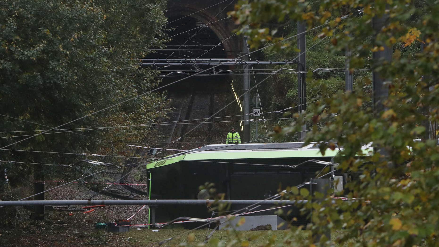 Nov. 9, 2016: An emergency services worker looks at a derailed tram in Croydon, south London.