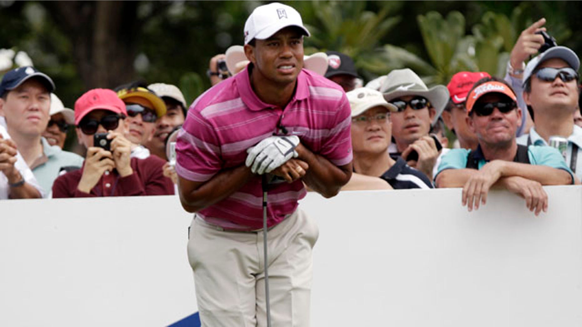 Nov. 8: Tiger Woods of the United States watches his ball after teeing off from the fourth hole during the Skins Games charity golf tournament, marking King Bhumibol's 60th year on the Thai throne, on the Amata Spring Country Club course in Chonburi province, southeastern Thailand.