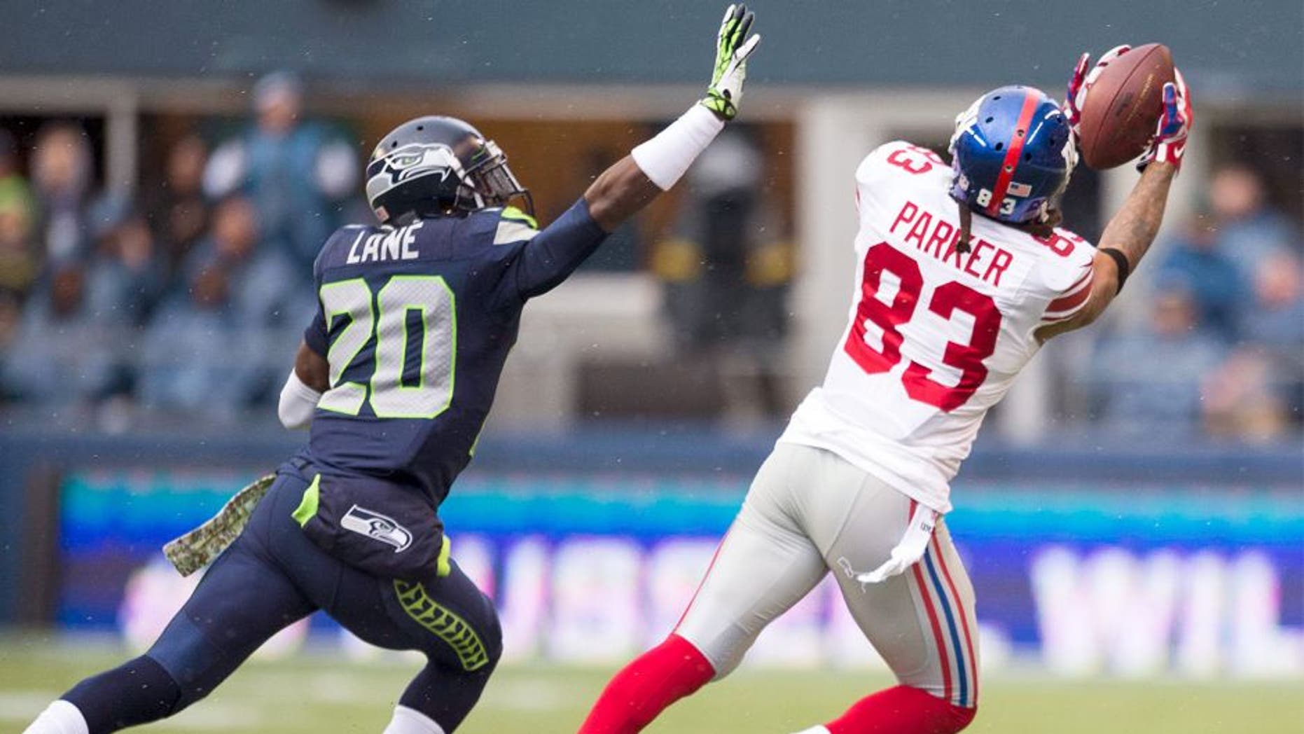 Nov 9, 2014; Seattle, WA, USA; New York Giants wide receiver Preston Parker (83) catches a pass over Seattle Seahawks cornerback Jeremy Lane (20) during the first half at CenturyLink Field. Seattle defeated New York 38-17. Mandatory Credit: Steven Bisig-USA TODAY Sports