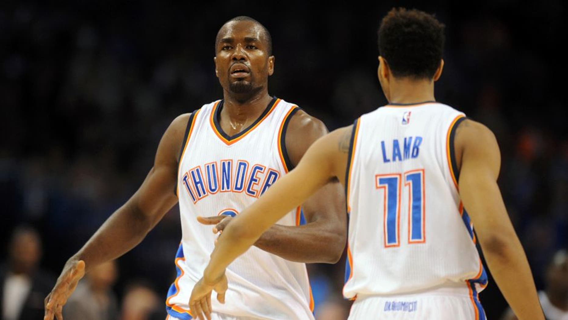 Nov 9, 2014; Oklahoma City, OK, USA; Oklahoma City Thunder forward Serge Ibaka (9) is congratulated by Oklahoma City Thunder guard Jeremy Lamb (11) after a dunk against the Sacramento Kings during the second quarter at Chesapeake Energy Arena. Mandatory Credit: Mark D. Smith-USA TODAY Sports