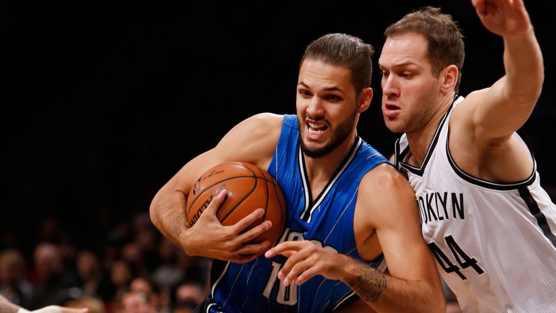 Orlando Magic's Evan Fournier (10), of France, drives against Brooklyn Nets' Bojan Bogdanovic (44), of Croatia, during the first quarter of an NBA basketball game Sunday, Nov. 9, 2014, in New York. (AP Photo/Jason DeCrow)