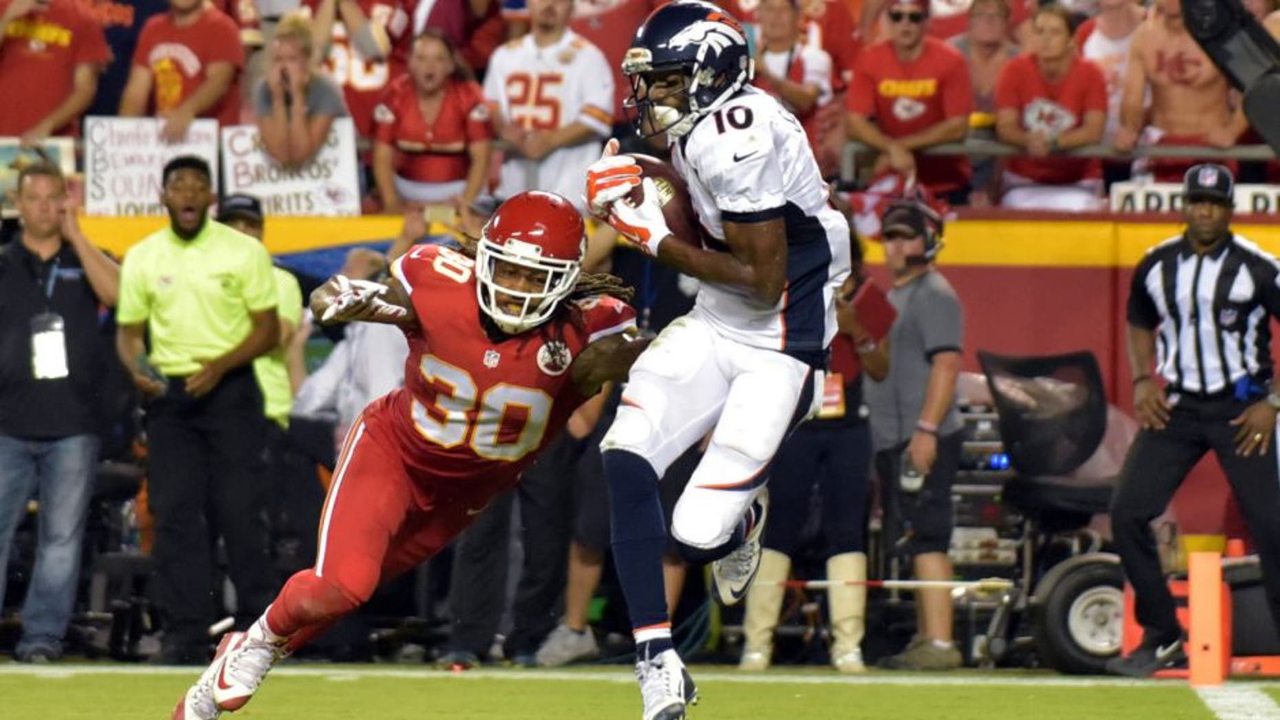 Sep 17, 2015; Kansas City, MO, USA; Denver Broncos wide receiver Emmanuel Sanders (10) catches a pass and scores a touchdown as Kansas City Chiefs cornerback Jamell Fleming (30) tries to defend during the second half at Arrowhead Stadium. The Broncos won 31-24. Mandatory Credit: Denny Medley-USA TODAY Sports