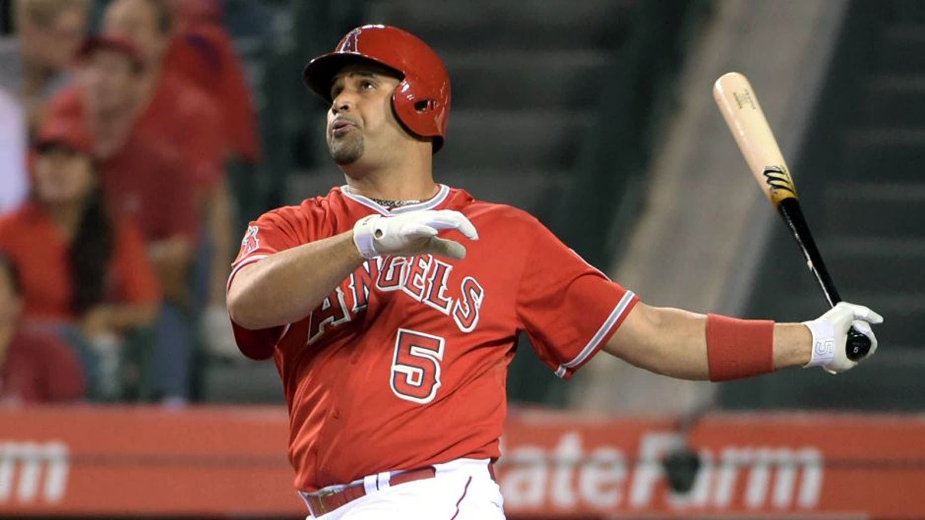 Sep 25, 2015; Anaheim, CA, USA; Los Angeles Angels first baseman Albert Pujols (5) follows through on a two-run home run in the first inning at Angel Stadium of Anaheim. Mandatory Credit: Kirby Lee-USA TODAY Sports