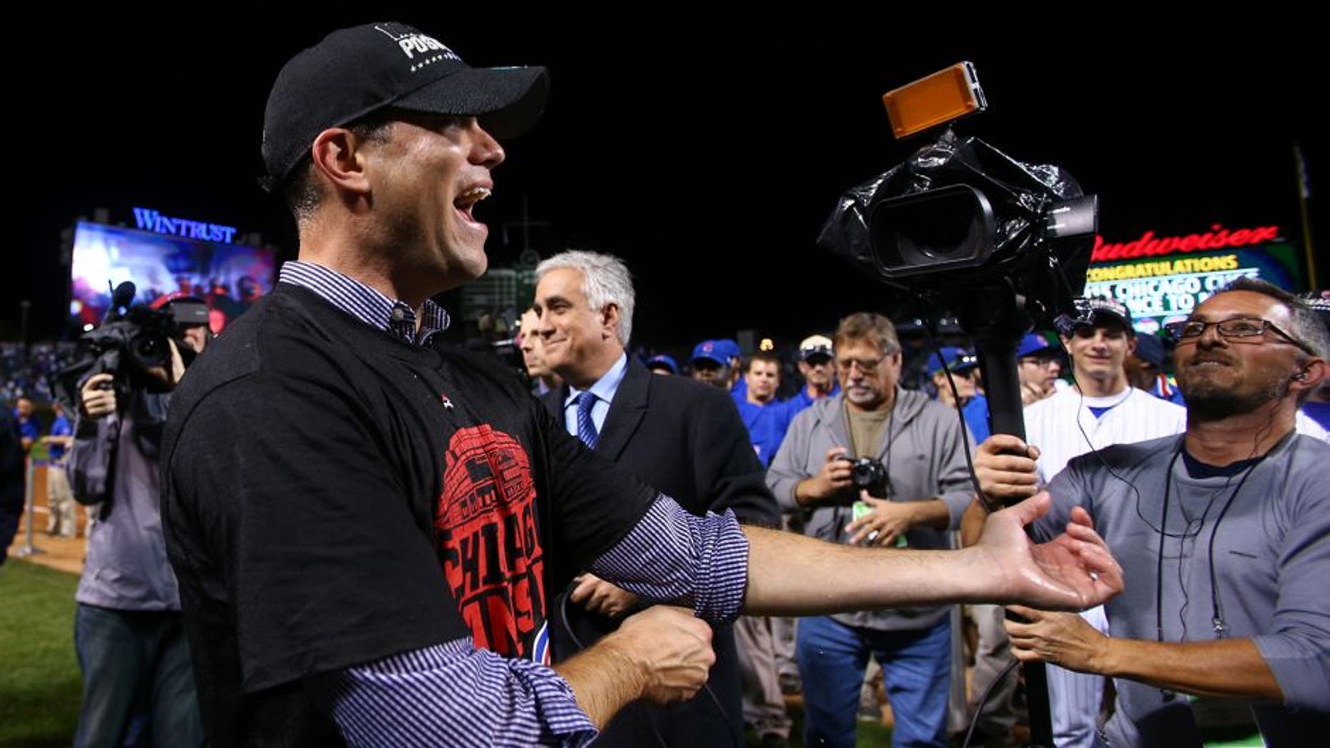 Oct 13, 2015; Chicago, IL, USA; Chicago Cubs president of baseball operations Theo Epstein celebrates on the field after defeating the St. Louis Cardinals in game four of the NLDS at Wrigley Field. Mandatory Credit: Jerry Lai-USA TODAY Sports