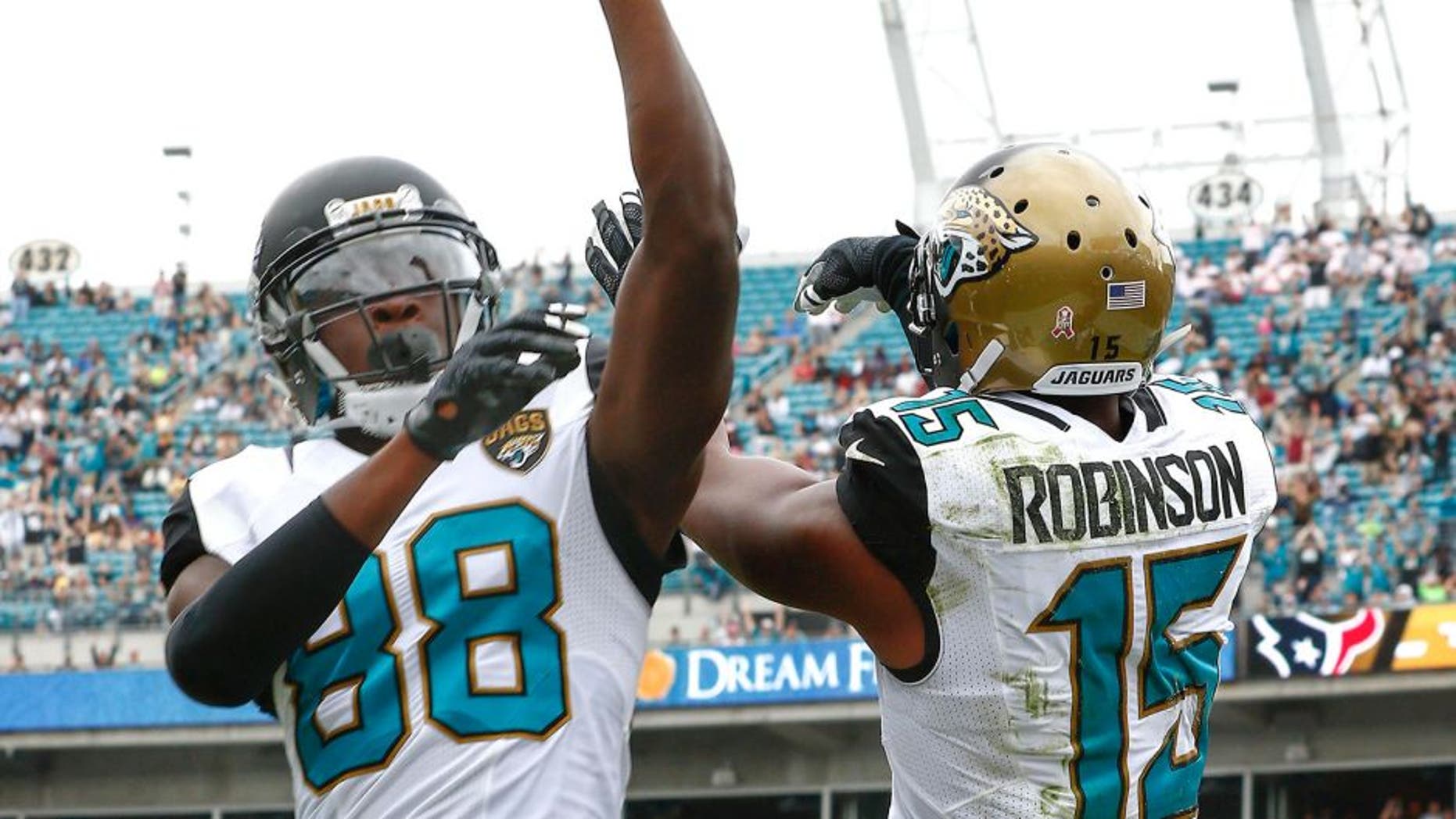Oct 18, 2015; Jacksonville, FL, USA; Jacksonville Jaguars wide receiver Allen Robinson (15) and wide receiver Allen Hurns (88) celebrate a touchdown during the second half of a football game against the Houston Texans at EverBank Field. Mandatory Credit: Reinhold Matay-USA TODAY Sports