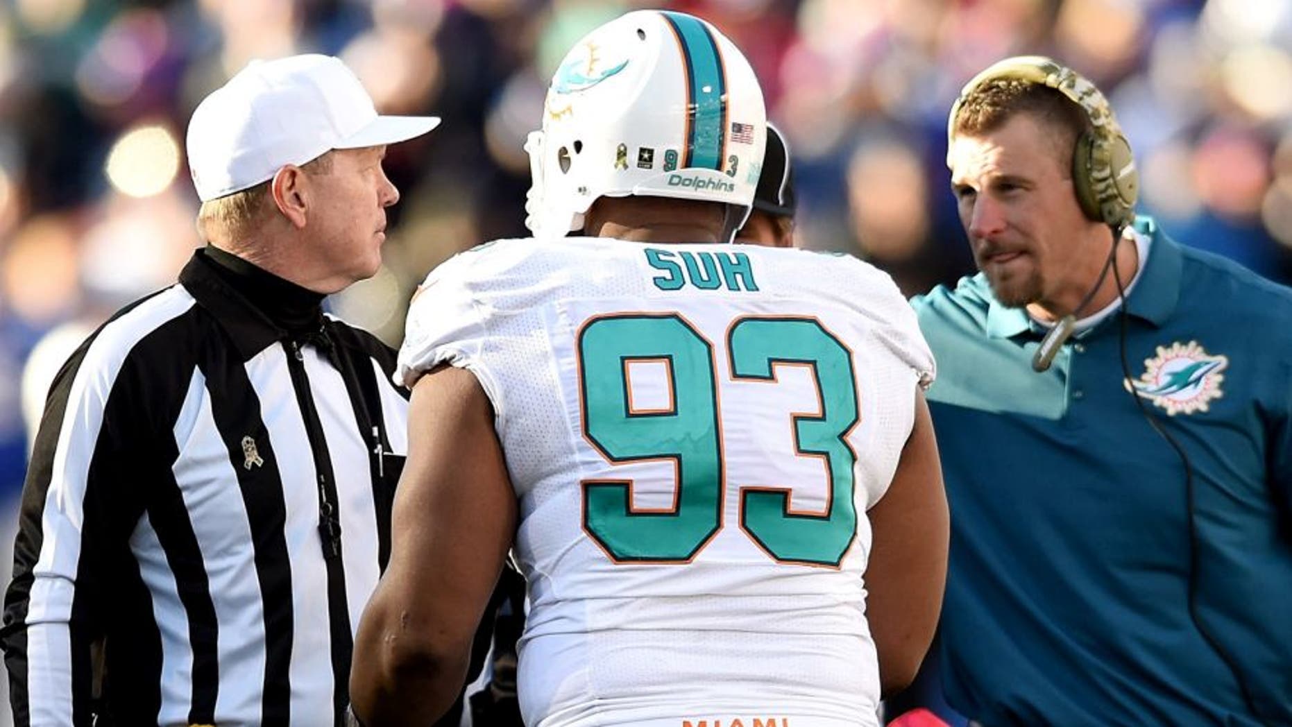 ORCHARD PARK, NY - NOVEMBER 08: Ndamukong Suh #93 of the Miami Dolphins talks to referee Carl Cheffers #51 as Interm Head Coach Dan Campbell of the Miami Dolphins listens during the second half against the Buffalo Bills at Ralph Wilson Stadium on November 8, 2015 in Orchard Park, New York. (Photo by Rich Barnes/Getty Images)