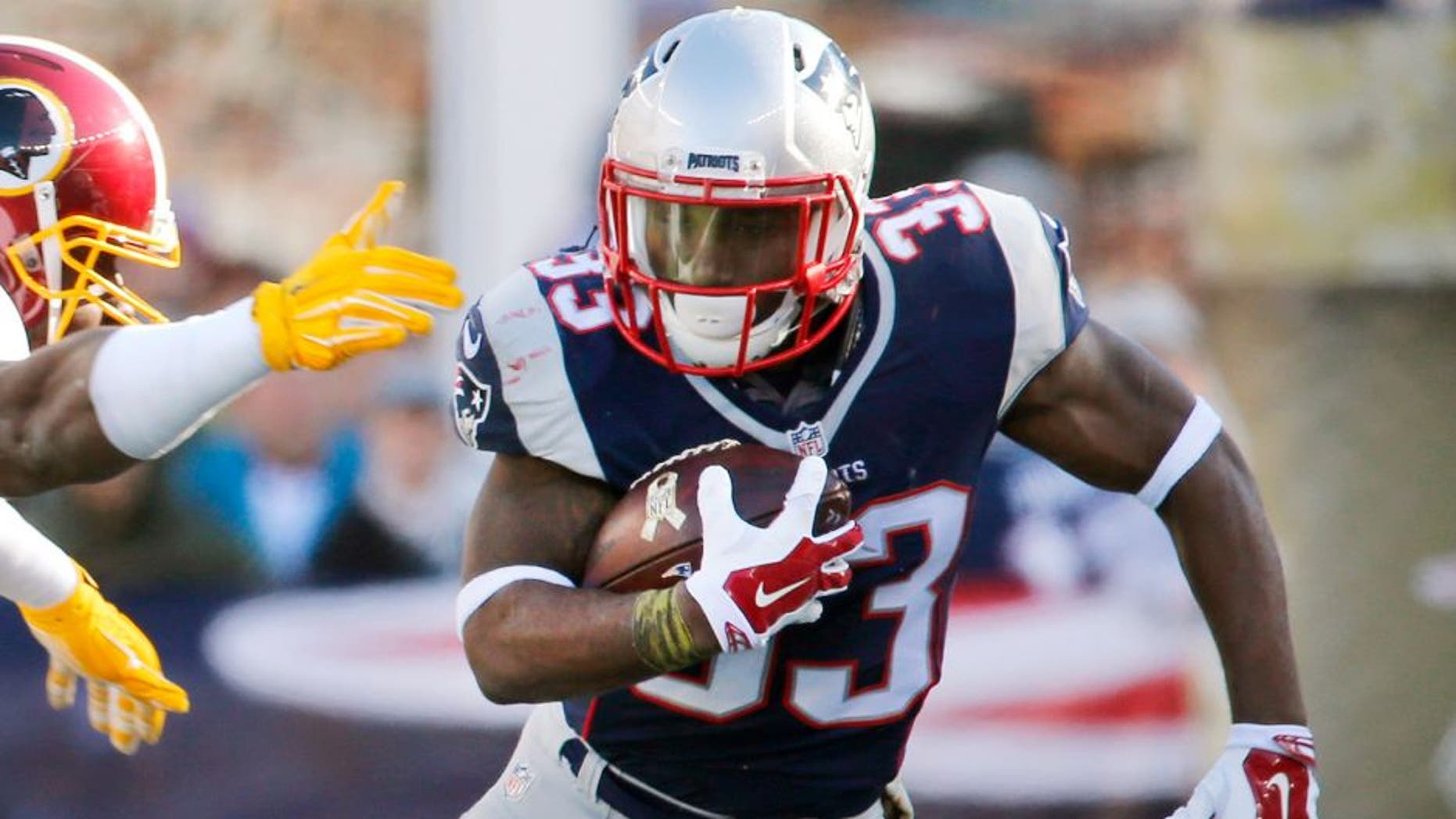 FOXBOROUGH, MA - NOVEMBER 8: Patriots player Dion Lewis was chased by Washington's Ricky Jean Francois in the first half. The New England Patriots hosted the Washington Redskins in a regular season NFL football game at Gillette Stadium, Sunday, Nov. 8, 2015. (Photo by Matthew J. Lee/The Boston Globe via Getty Images)