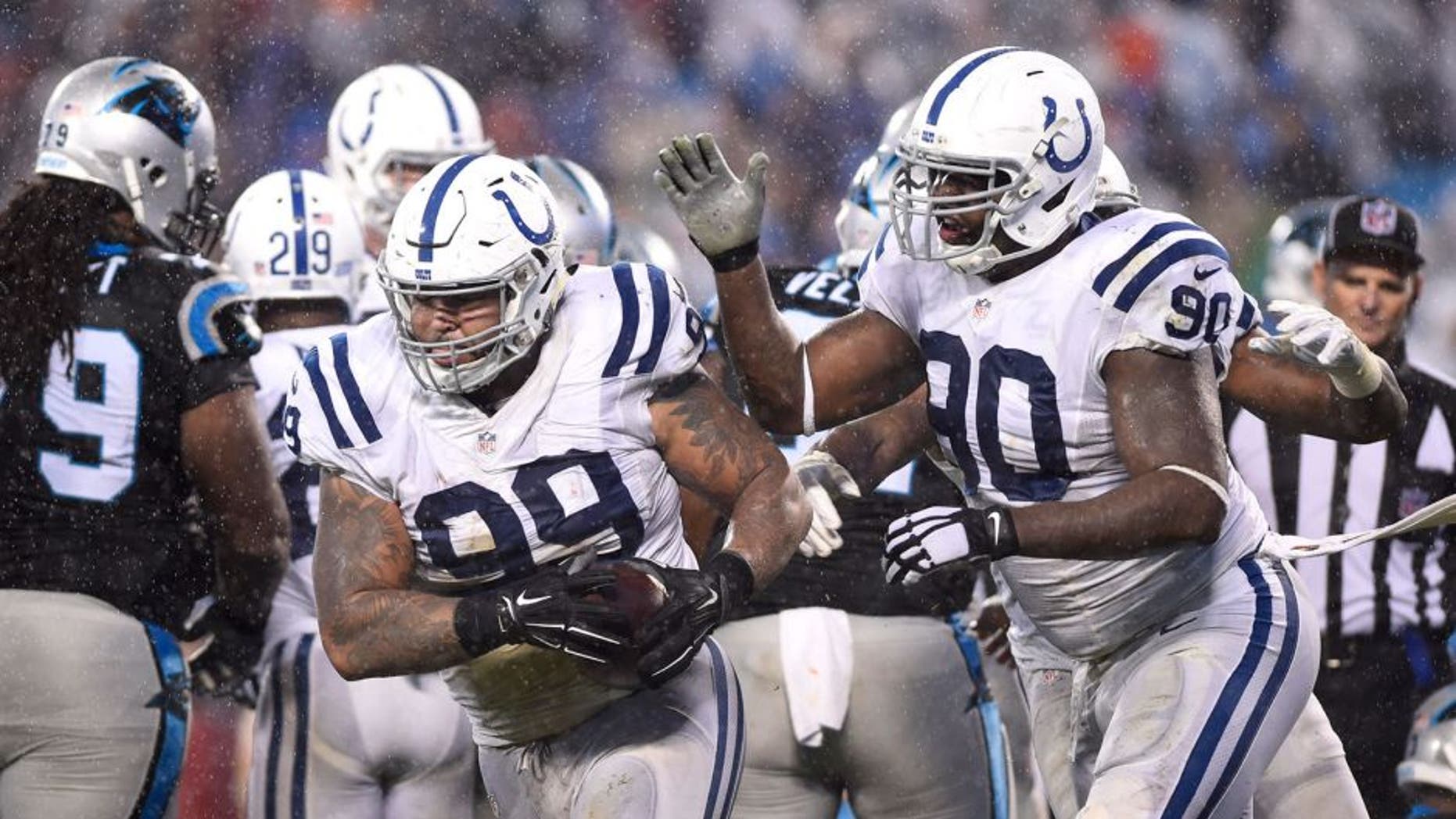 Nov 2, 2015; Charlotte, NC, USA; Indianapolis Colts defensive tackle Billy Winn (99) recovers a fumble and celebrates with defensive end Kendall Langford (90) in the third quarter at Bank of America Stadium. Mandatory Credit: Bob Donnan-USA TODAY Sports