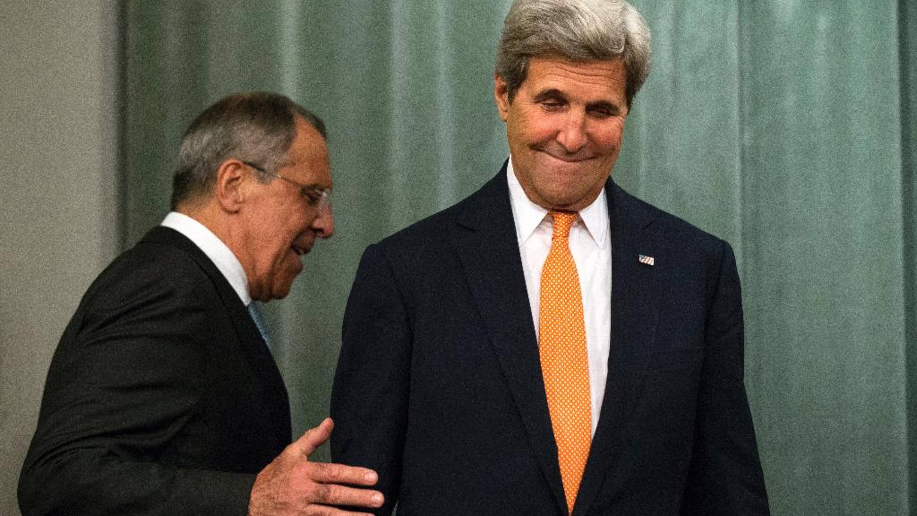 U.S. Secretary of State John Kerry, right, and Russian Foreign Minister Sergey Lavrov arrive to a news conference after their long talks in Moscow, Russia, Friday, July 15, 2016. The United States is offering Russia a broad new military partnership in Syria. (AP Photo/Alexander Zemlianichenko)