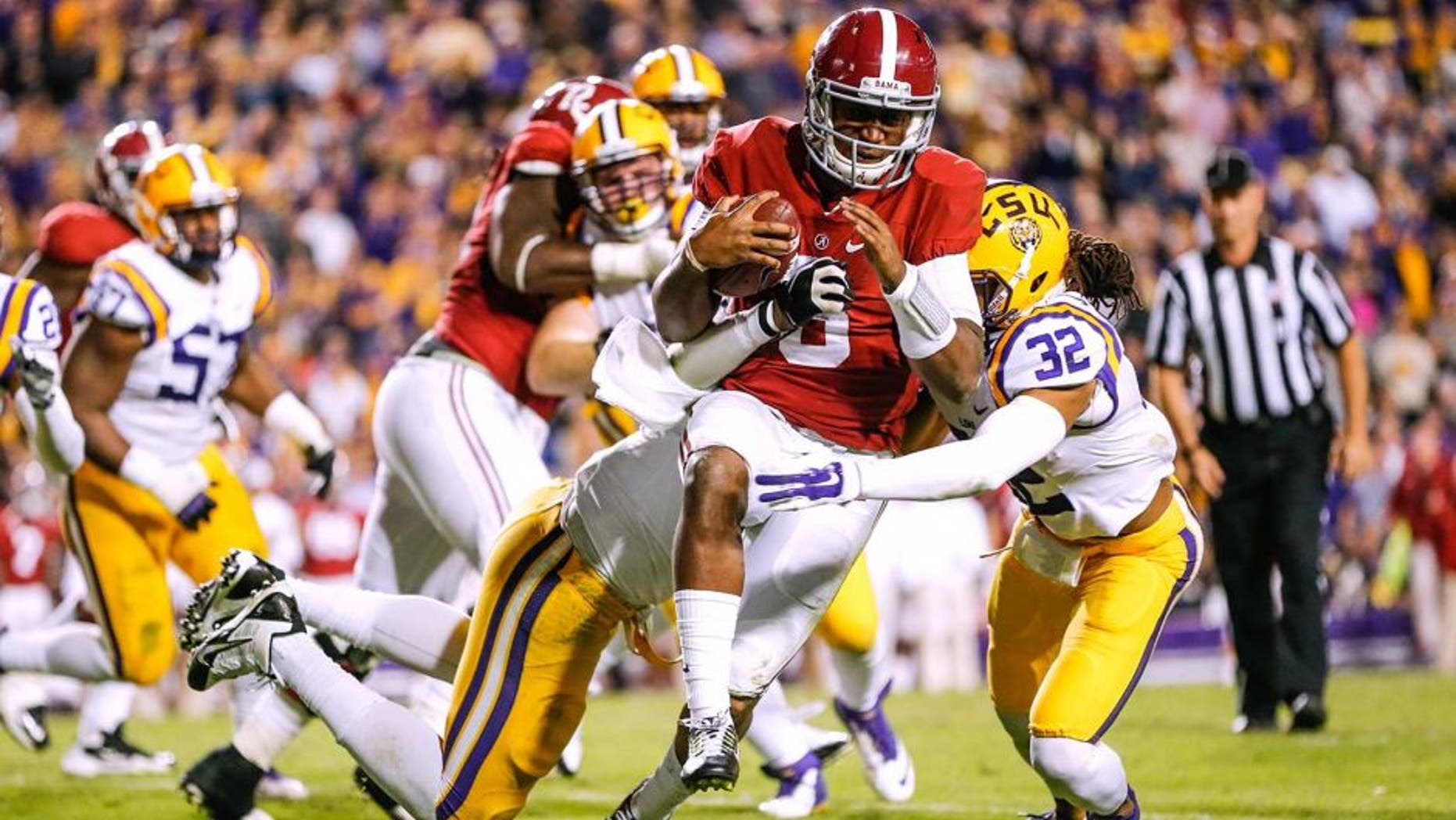 Nov 8, 2014; Baton Rouge, LA, USA; Alabama Crimson Tide quarterback Blake Sims (6) is tackled by LSU Tigers defensive end Jermauria Rasco (59) during the fourth quarter of a game at Tiger Stadium. Alabama defeated LSU 20-13. Mandatory Credit: Derick E. Hingle-USA TODAY Sports