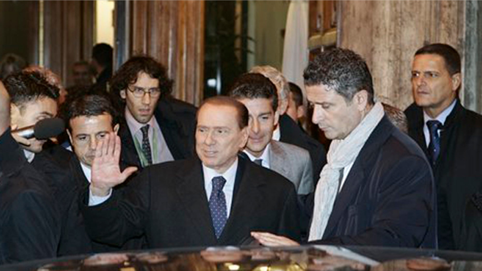 November 10, 2011: Italian Premier Silvio Berlusconi, center, leaves at the end of a meeting with his allies in the Italian Senate in Rome.
