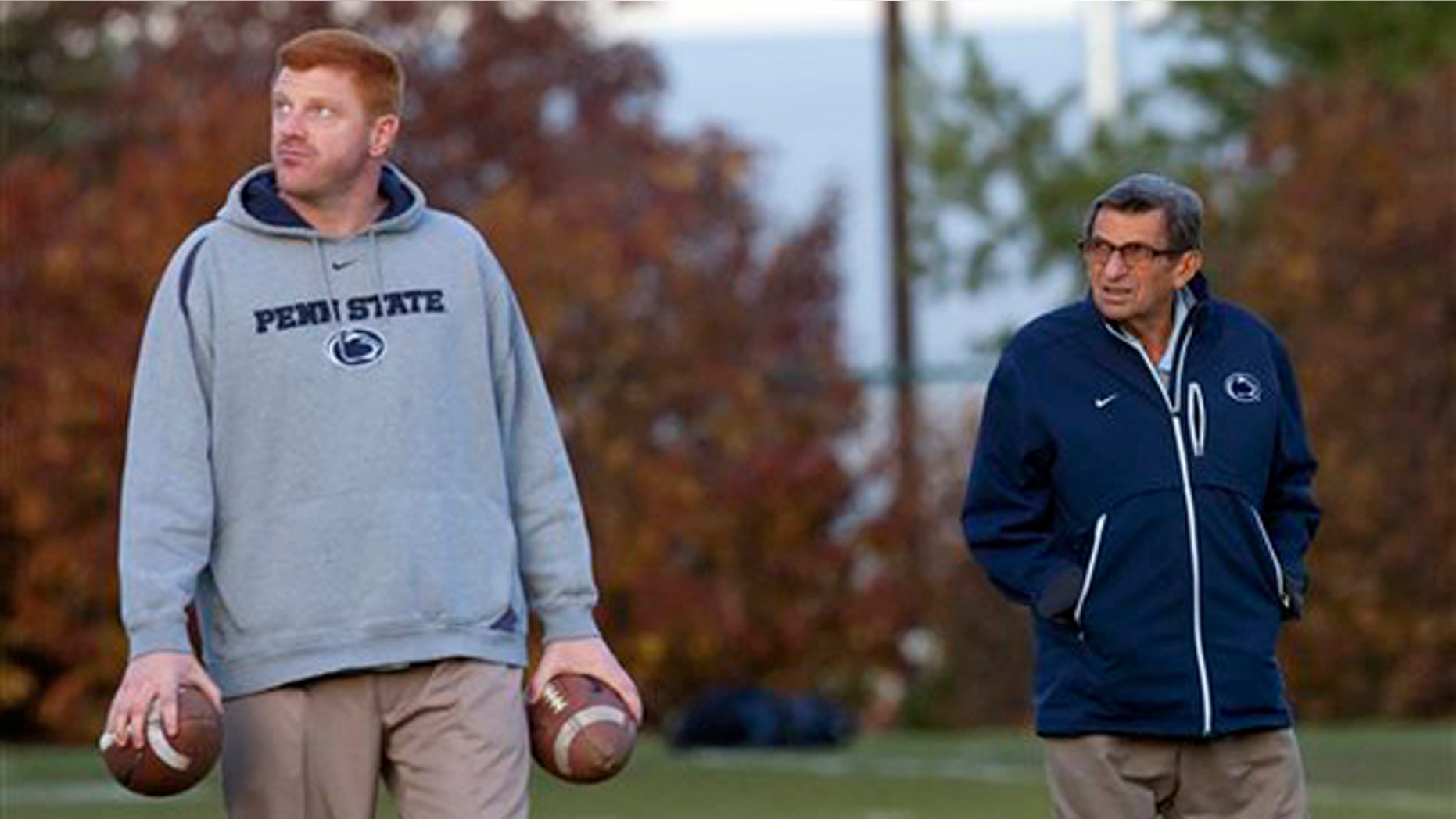 November 9, 2011: Former Penn State football coach Joe Paterno, right, and assistant coach Mike McQueary walk the field during practice.