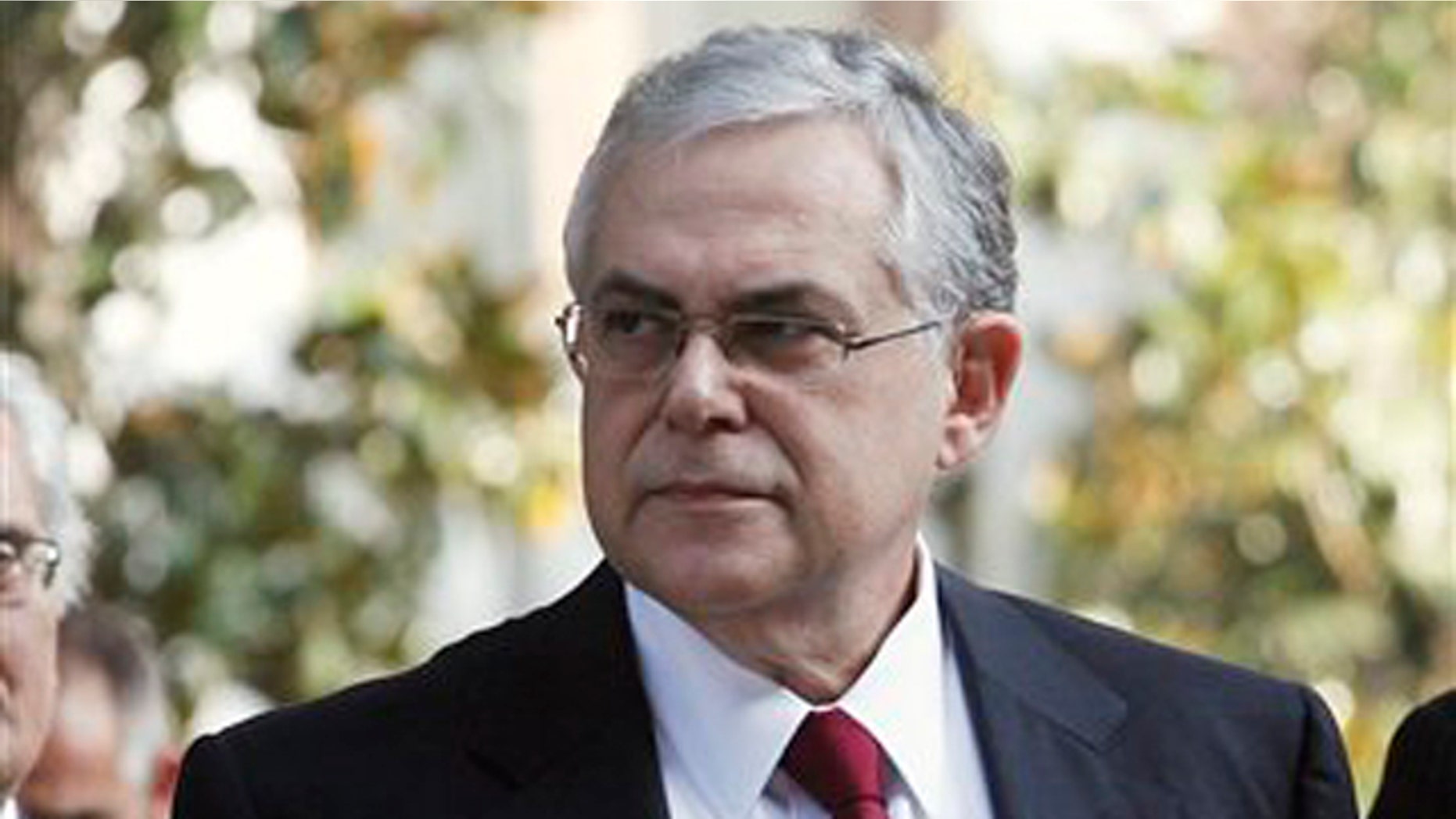 November 10, 2011: Greece's new Prime Minister Lucas Papademos arrives to deliver a statement outside the presidential palace in Athens.