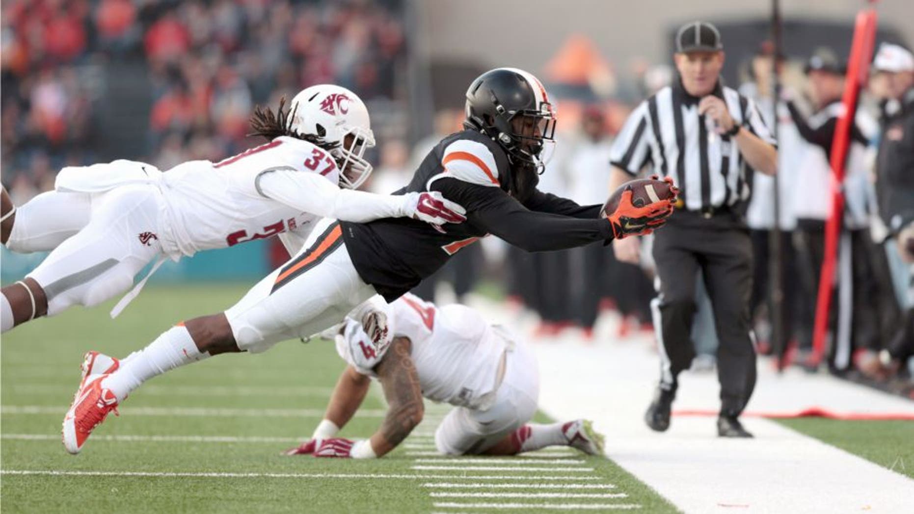 Nov 8, 2014; Corvallis, OR, USA; Washington State Cougars safety Sulaiman Hameed (37) tackles Oregon State Beavers wide receiver Hunter Jarmon (7) at Reser Stadium. Mandatory Credit: Scott Olmos-USA TODAY Sports