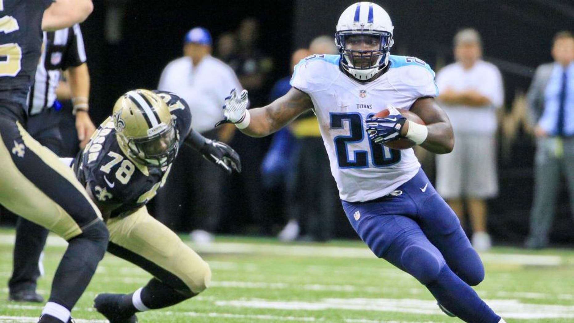 Nov 8, 2015; New Orleans, LA, USA; Tennessee Titans running back Antonio Andrews (26) runs past New Orleans Saints defensive end Bobby Richardson (78) during the second half of a game at the Mercedes-Benz Superdome. The Titans defeated the Saints 34-28 in overtime. Mandatory Credit: Derick E. Hingle-USA TODAY Sports