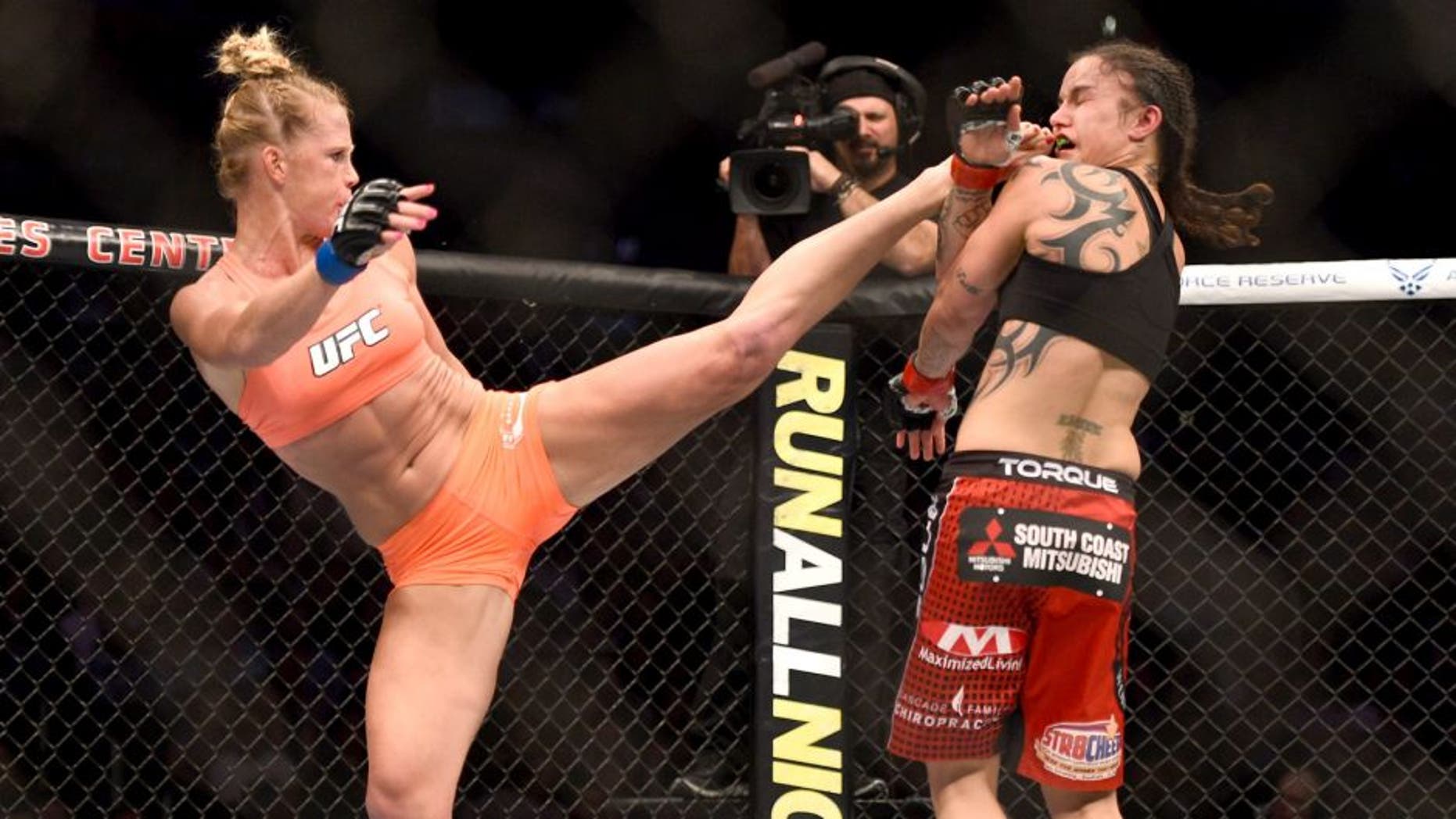 LOS ANGELES, CA - FEBRUARY 28: (L) Holly Holm kicks Raquel Pennington in their women's bantamweight bout during the UFC 184 event at Staples Center on February 28, 2015 in Los Angeles, California. (Photo by Jeff Bottari/Zuffa LLC/Zuffa LLC via Getty Images)