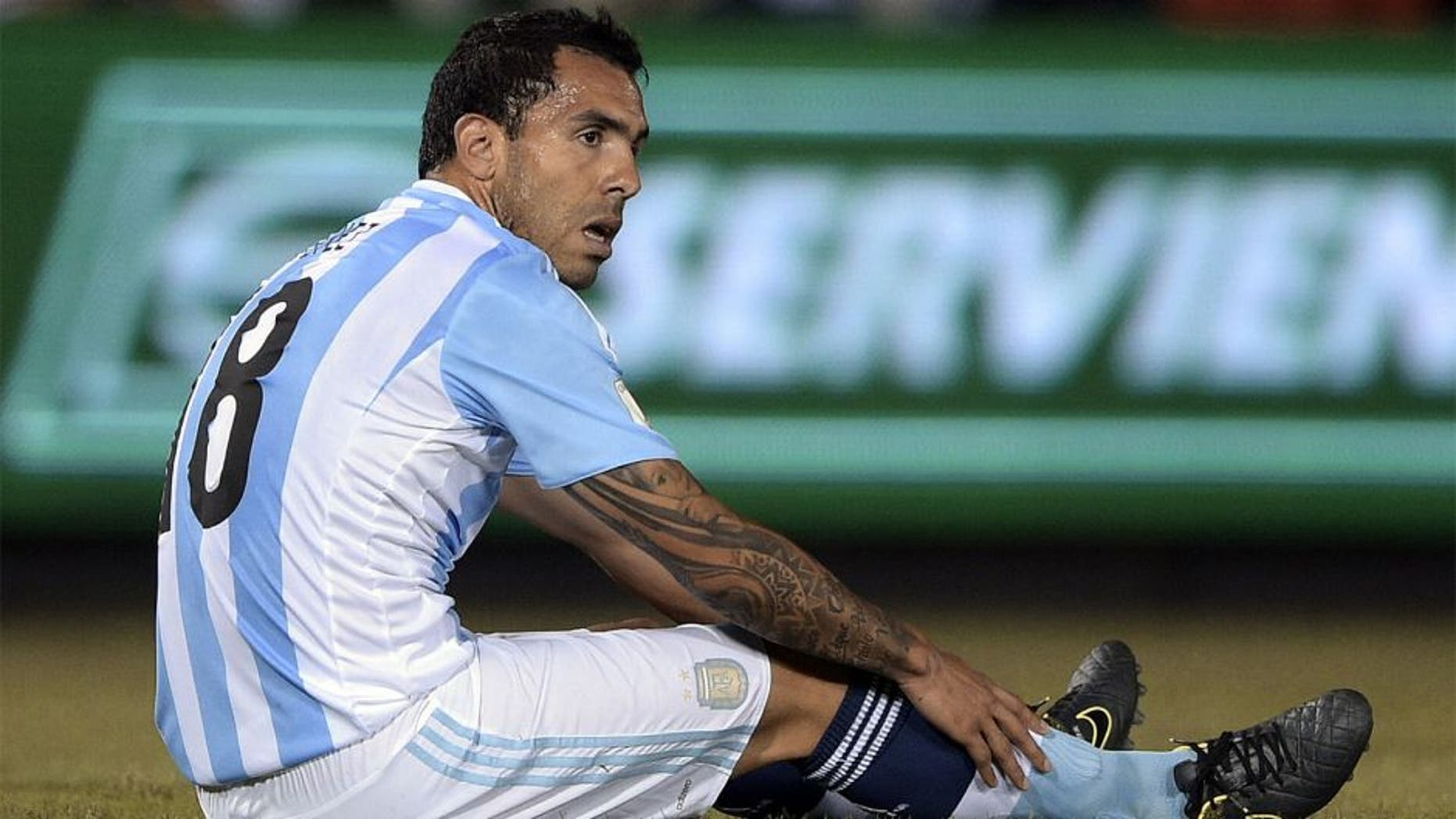 Argentina's forward Carlos Tevez sits on the ground during the Russia 2018 FIFA World Cup South American Qualifiers football match against Paraguay, at the Defensores del Chaco stadium in Asuncion, on October 13, 2015. AFP PHOTO / JUAN MABROMATA (Photo credit should read JUAN MABROMATA/AFP/Getty Images)