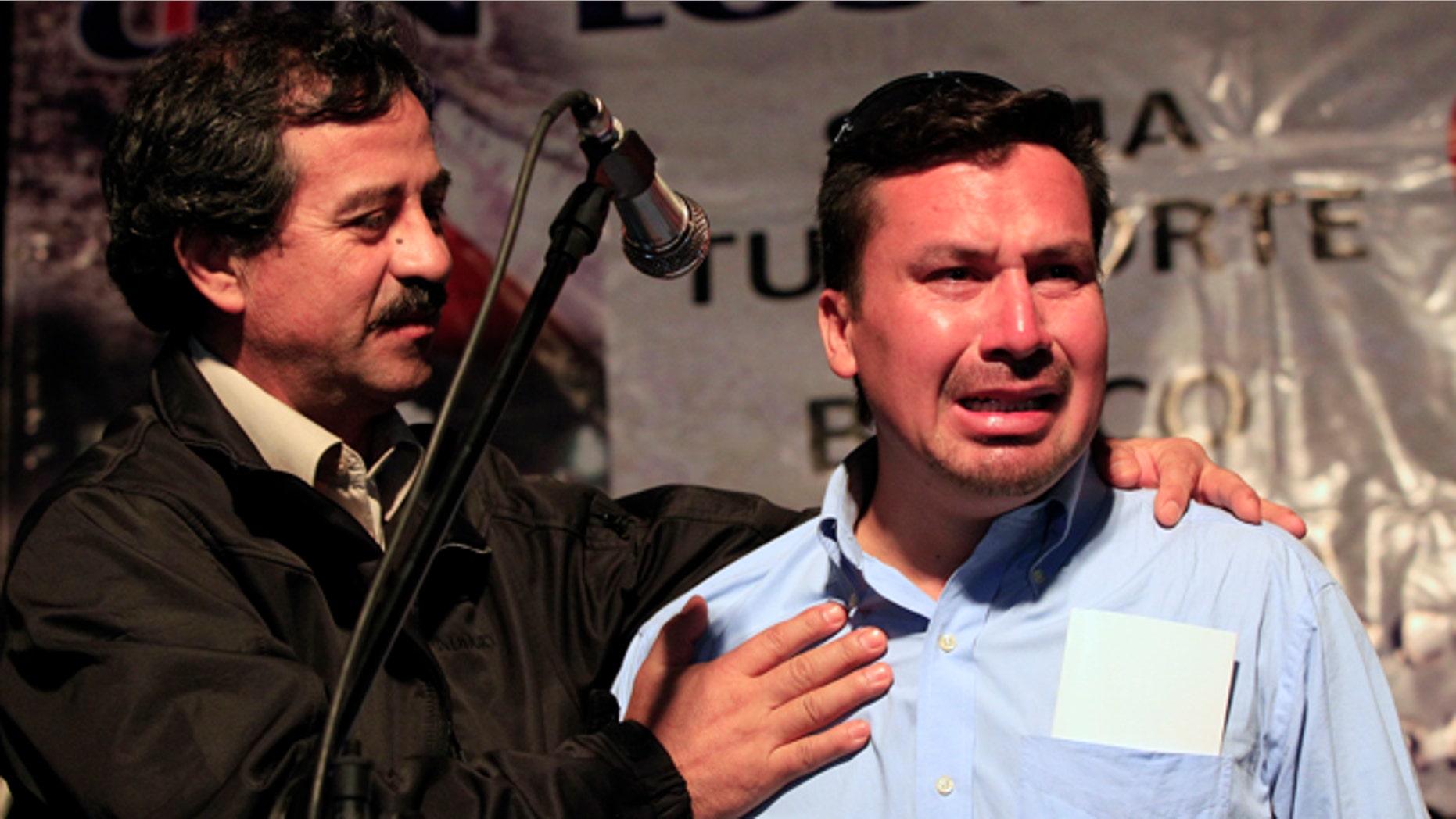 Oct. 19: Rescued miner Edison Pena, right, cries while fellow rescued miner Juan Illanes supports him during a ceremony honoring the miners in Caldera, Chile.