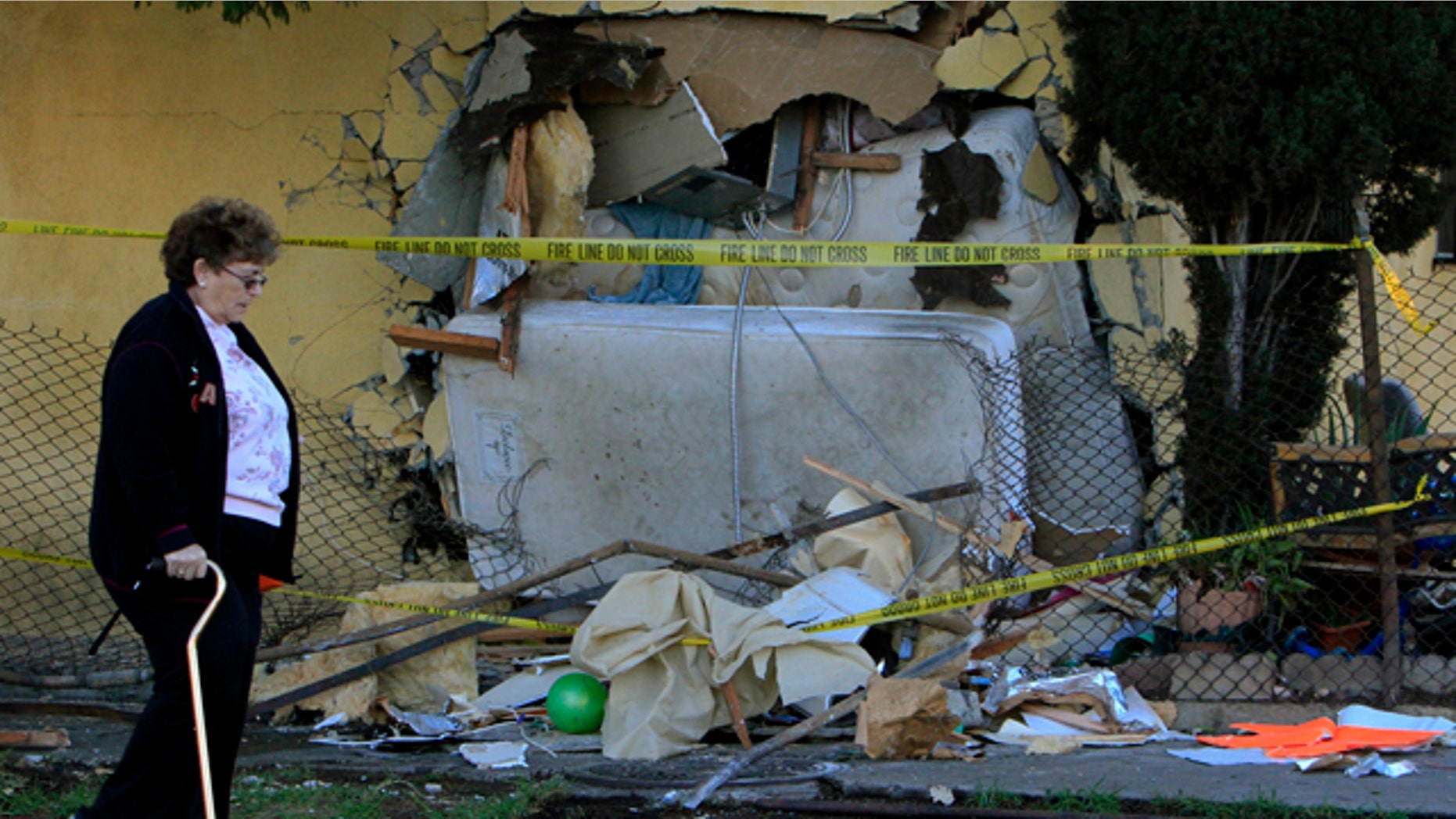 Nov. 1: A woman walks by a house that a pick up truck was driven into in Los Angeles.