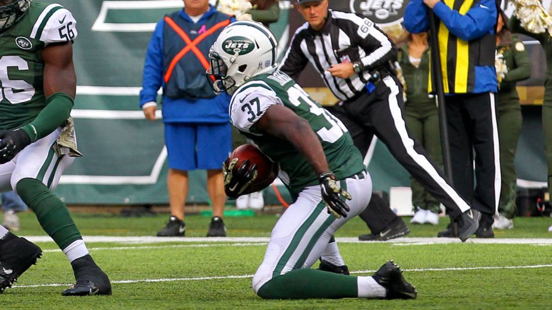 Nov 9, 2014; East Rutherford, NJ, USA; New York Jets free safety Jaiquawn Jarrett (37) returns an interception thrown by Pittsburgh Steelers quarterback Ben Roethlisberger (7) (not shown) during the first half at MetLife Stadium. Mandatory Credit: Ed Mulholland-USA TODAY Sports