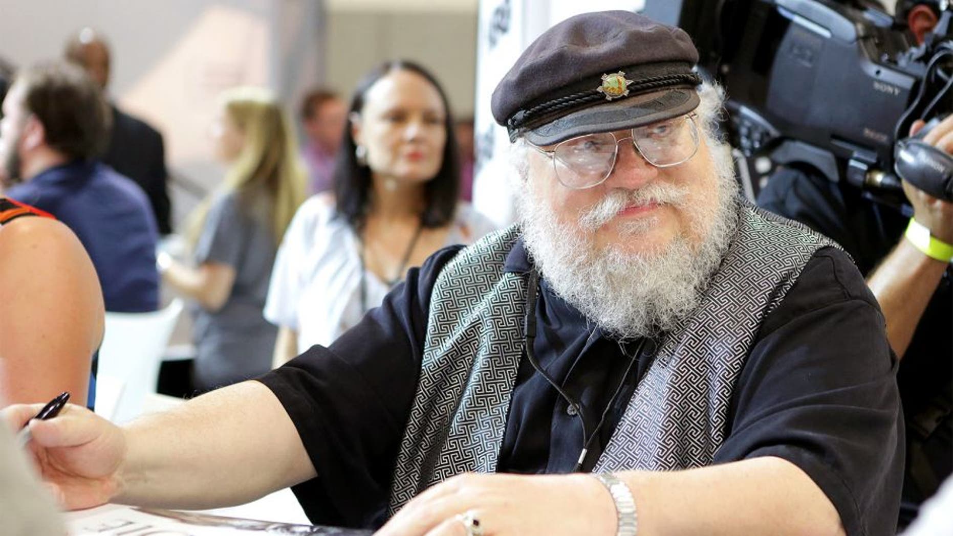 SAN DIEGO, CA - JULY 25: Writer George R.R. Martin of "Game of Thrones" signs autographs during the 2014 Comic-Con International Convention-Day 3 at the San Diego Convention Center on July 25, 2014 in San Diego, California. (Photo by Tiffany Rose/Getty Images)