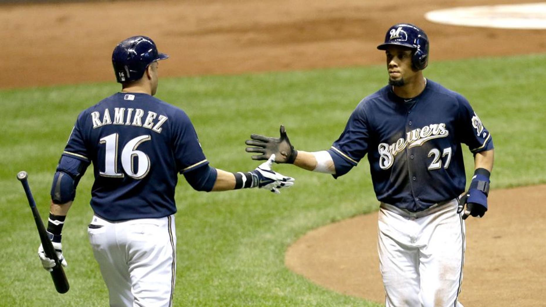 MILWAUKEE, WI - SEPTEMBER 12: Carlos Gomez #27 of the Milwaukee Brewers celebrates with Aramis Ramirez #16 after getting driven home on a single hit by Jonathan Lucroy in the bottom of the fourth inning against the Cincinnati Reds against the Milwaukee Brewers during the game at Miller Park on September 12, 2014 in Milwaukee, Wisconsin. (Photo by Mike McGinnis/Getty Images)