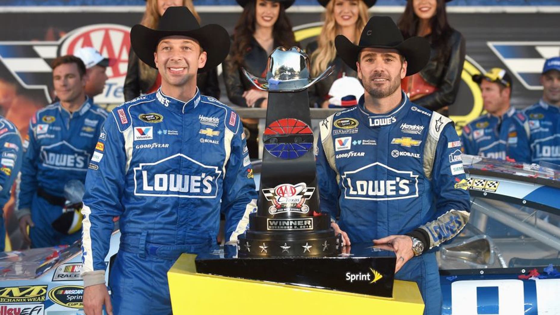 FORT WORTH, TX - NOVEMBER 08: Jimmie Johnson, driver of the #48 Lowe's Chevrolet, and crew chief Chad Knaus celebrate in victory lane with the trophy after winning the NASCAR Sprint Cup Series AAA Texas 500 at Texas Motor Speedway on November 8, 2015 in Fort Worth, Texas. (Photo by Rainier Ehrhardt/NASCAR via Getty Images)